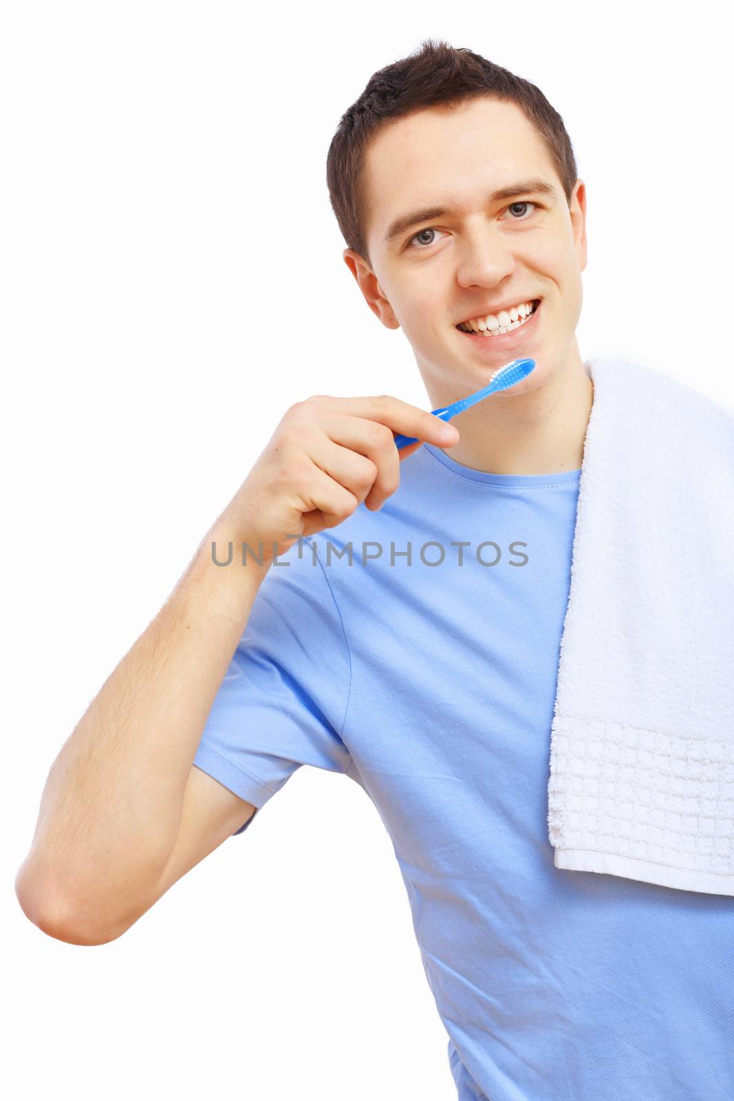 Young man at home brushing teeth in the morning