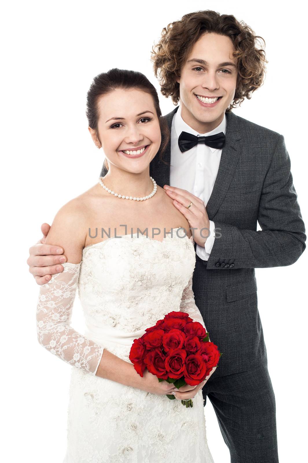 Smiling newlywed couple isolated against white background