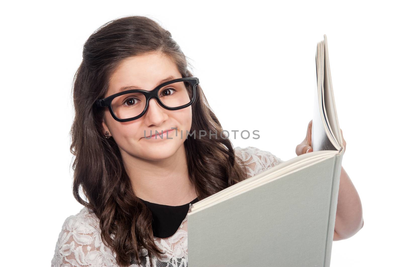 Brainy clever teenager with big glasses reading a big book on white background.