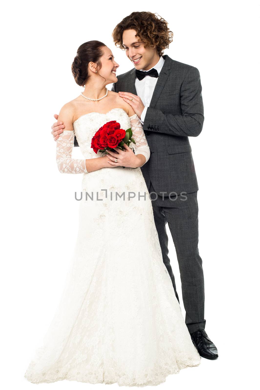 Romantic couple in bridal attire lost in each other