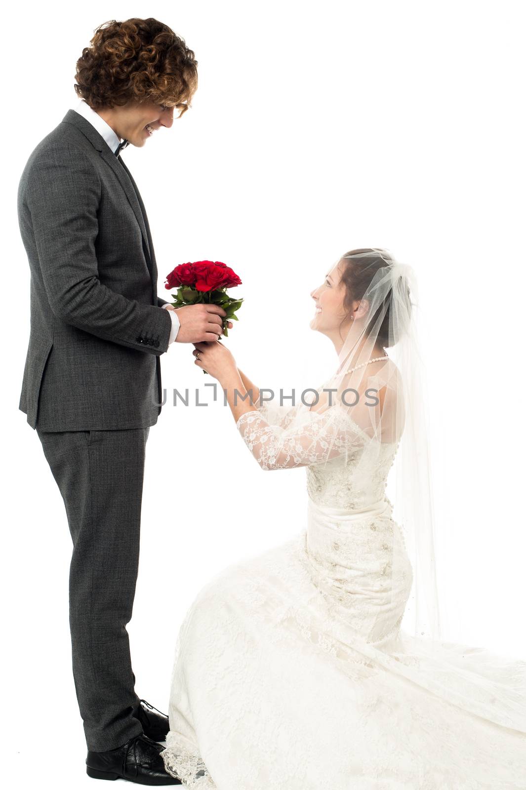 Gorgeous bride kneeling down and proposing handsome guy