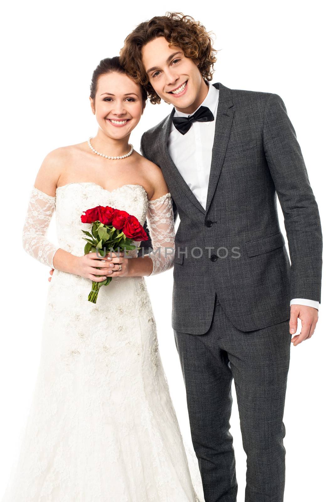 Lovely newlywed couple posing for a portrait by stockyimages