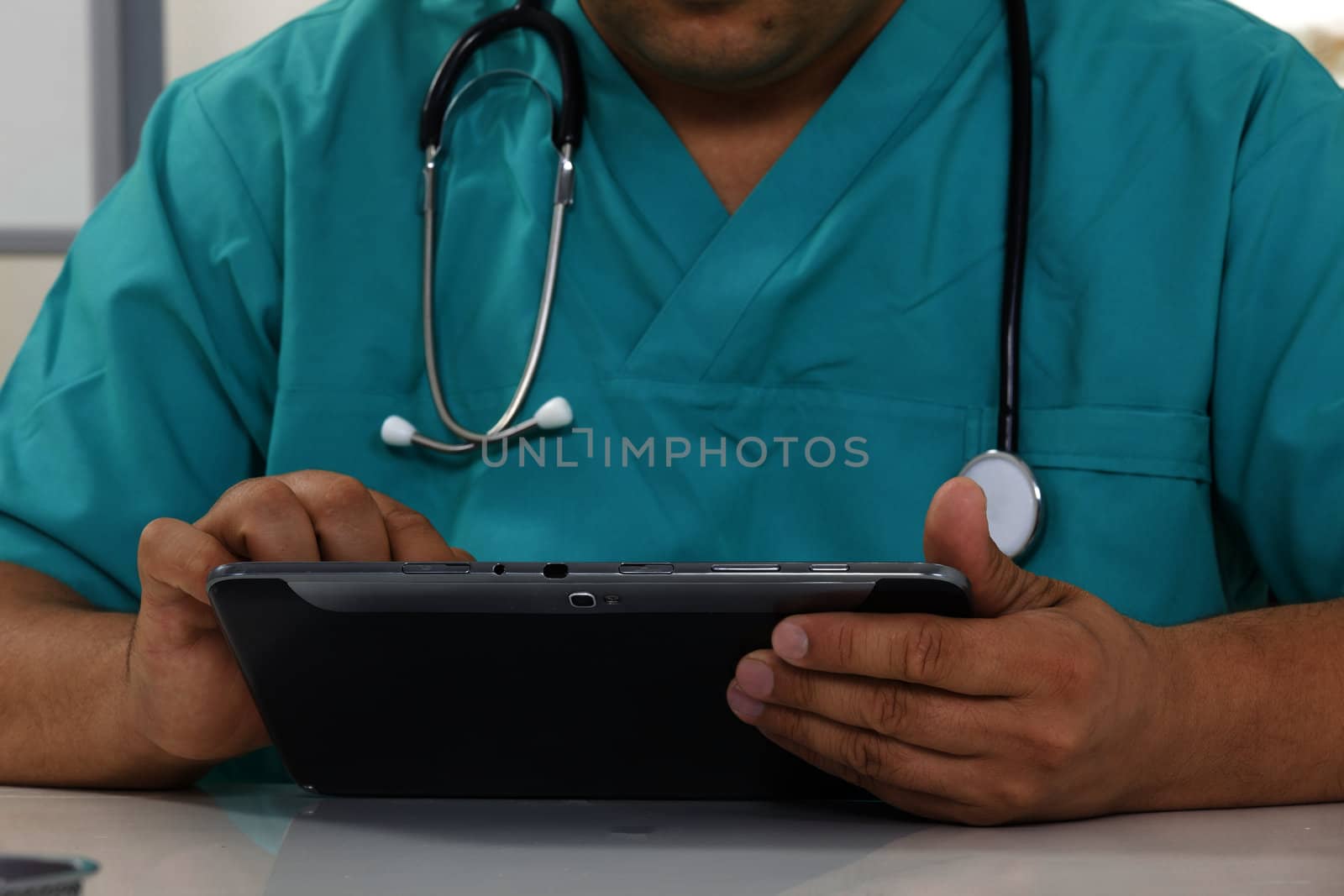 Doctor working on a digital tablet  by senkaya