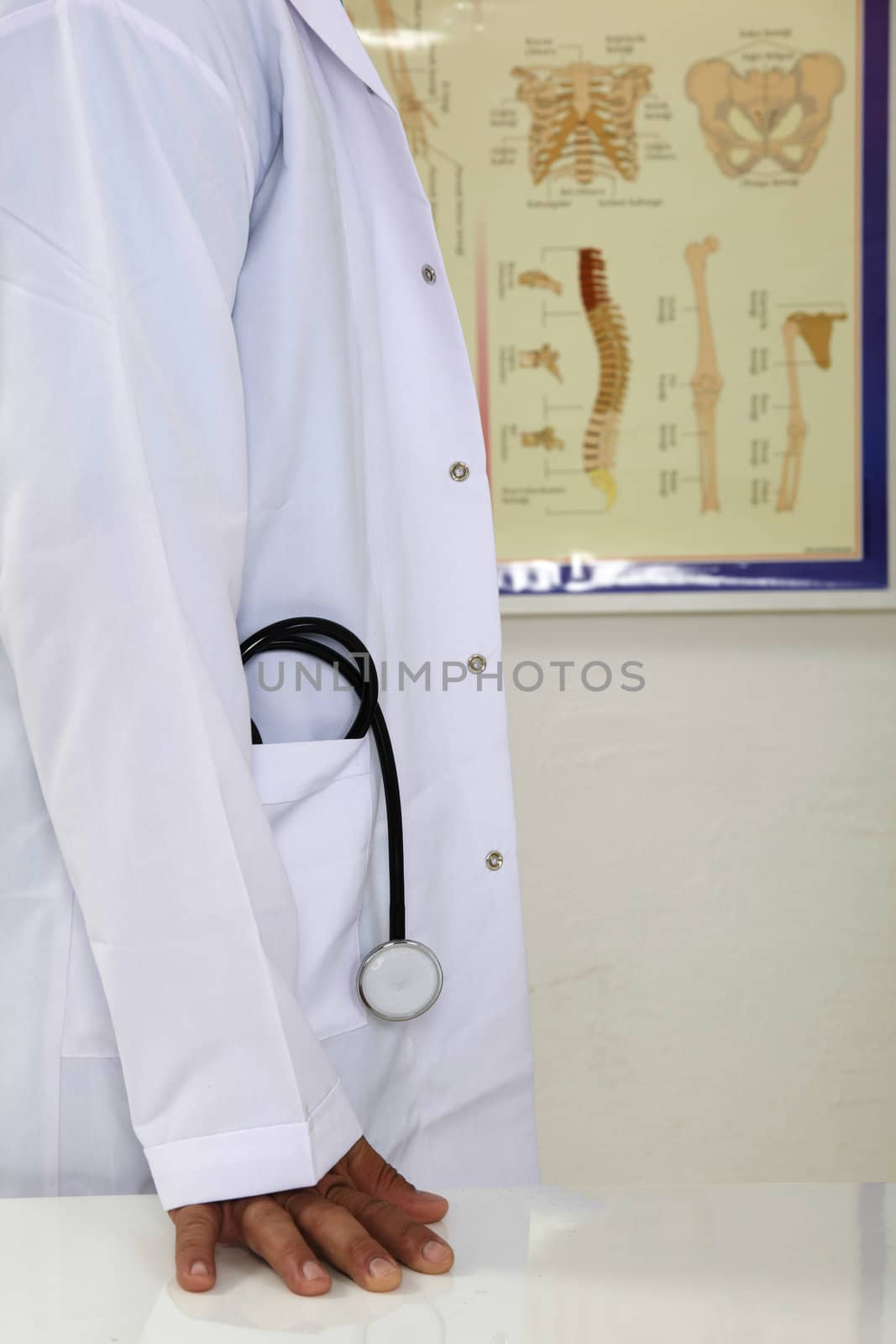 Closeup of male doctor hand touching a table.