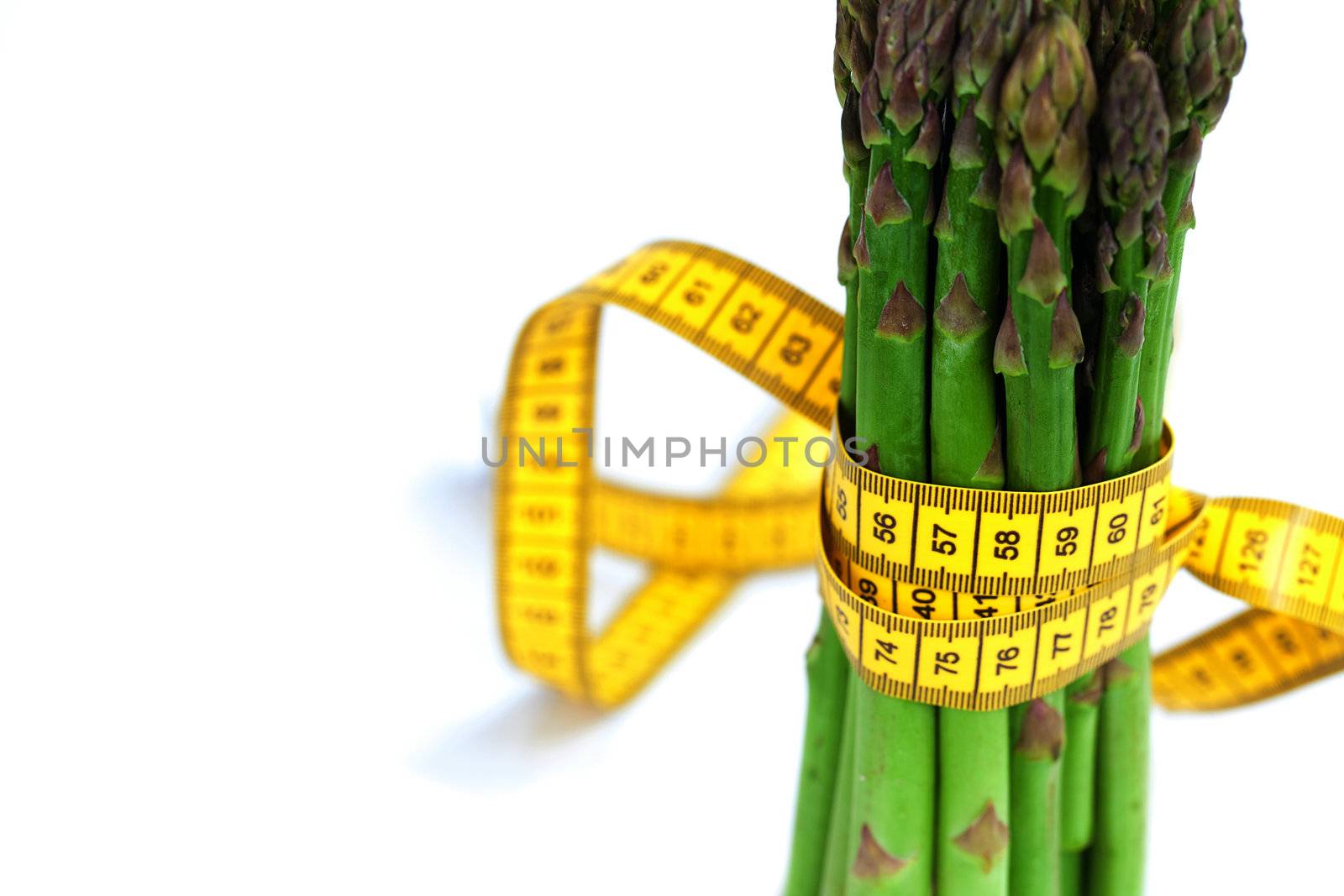 asparagus tied with measuring tape isolated on white by jannyjus