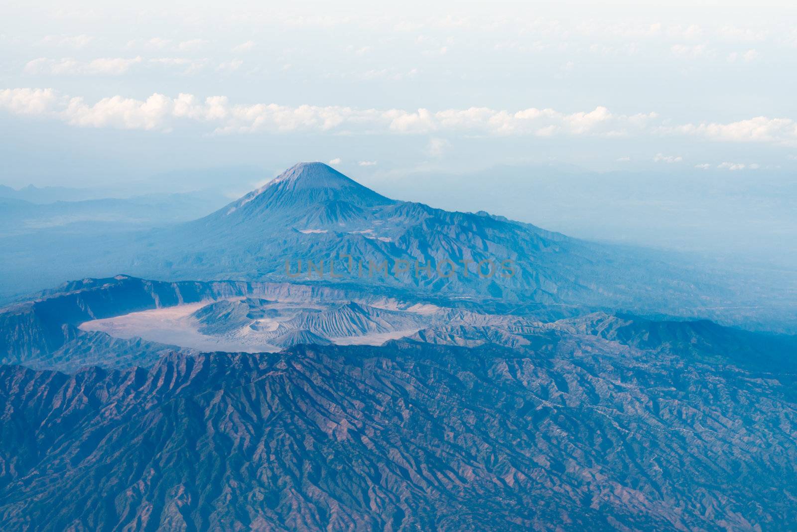 Big volcano crater with other volcano top on background, bird's eye view. Java island, Indonesia