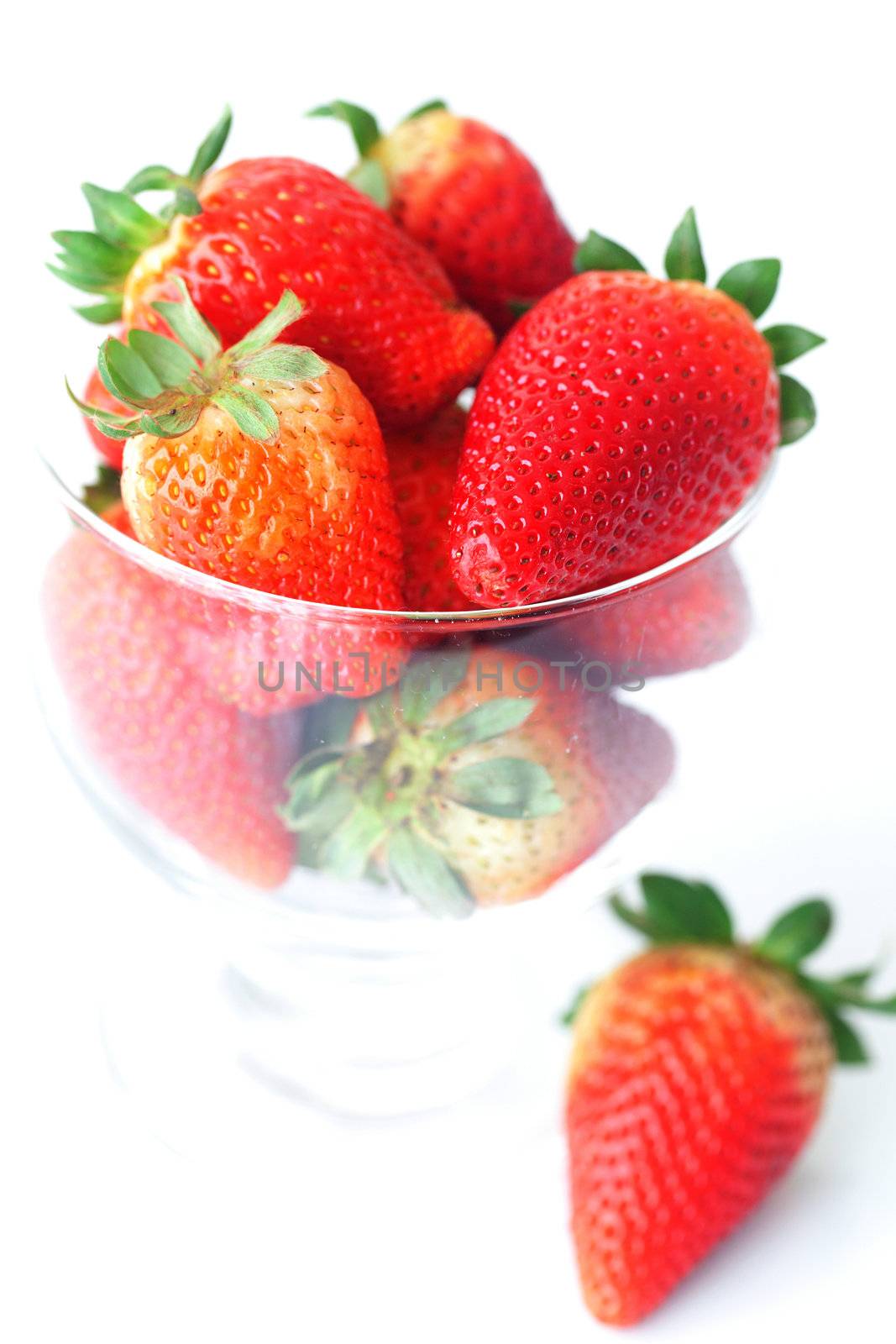 big red strawberries in a glass bowl by jannyjus