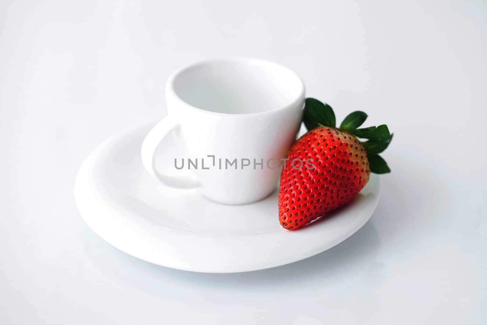 white cup with saucer and strawberries by jannyjus
