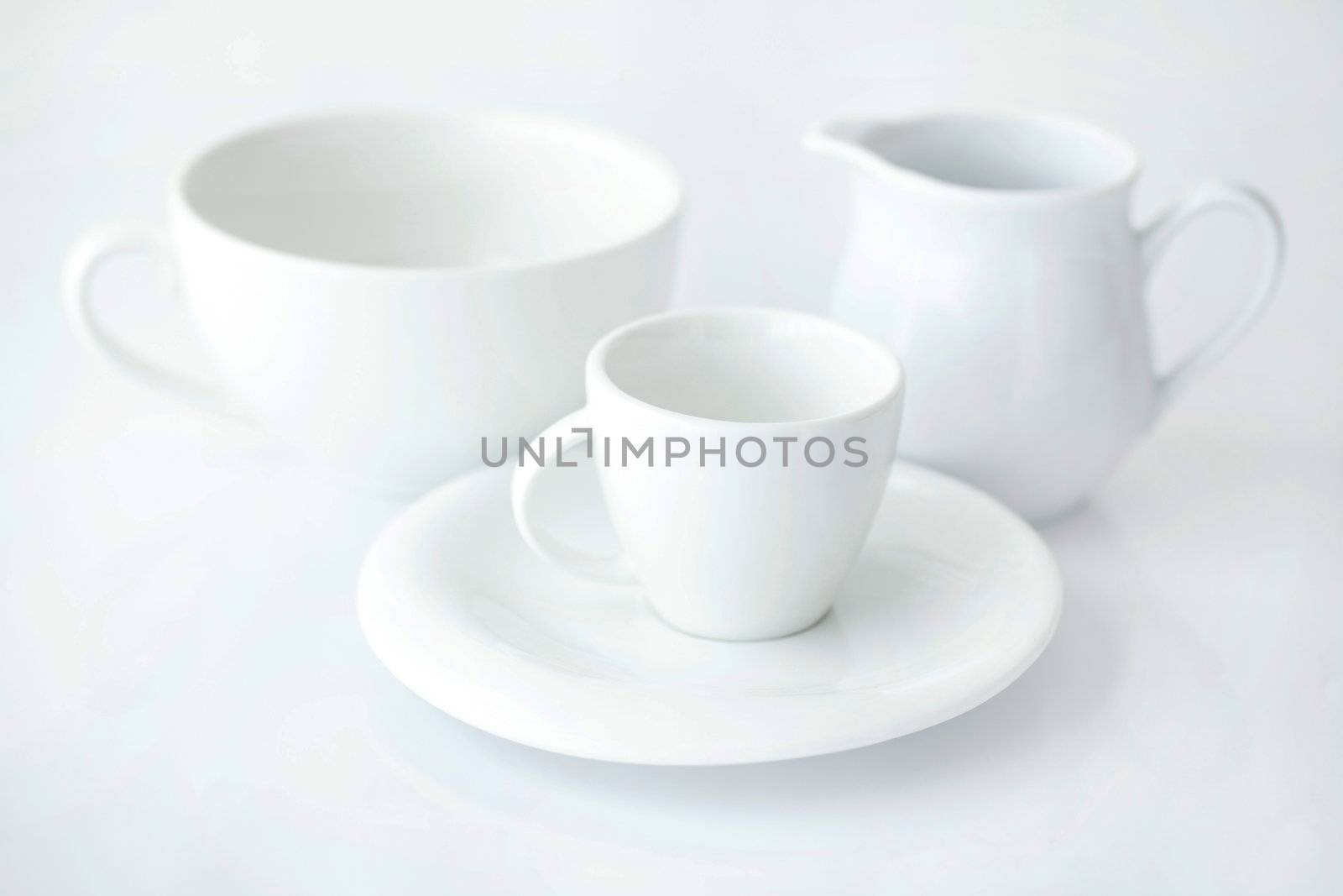 white cup with saucer and milk jug  by jannyjus