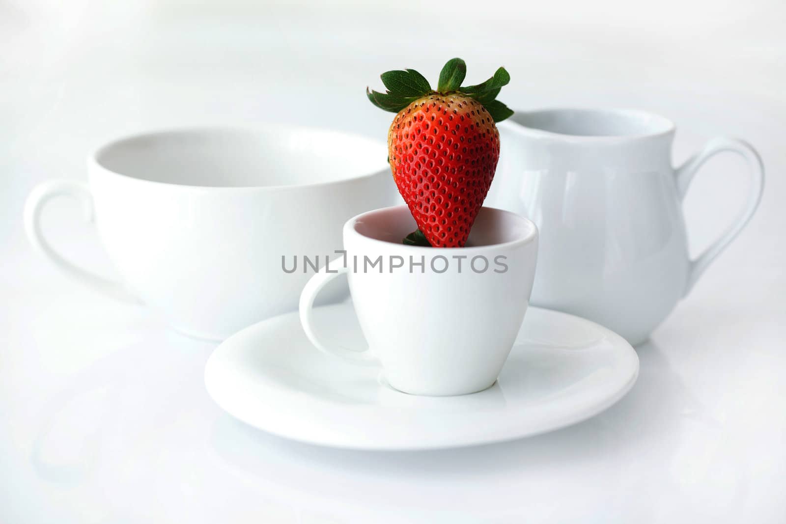 white cup with saucer, milk jug and strawberry by jannyjus