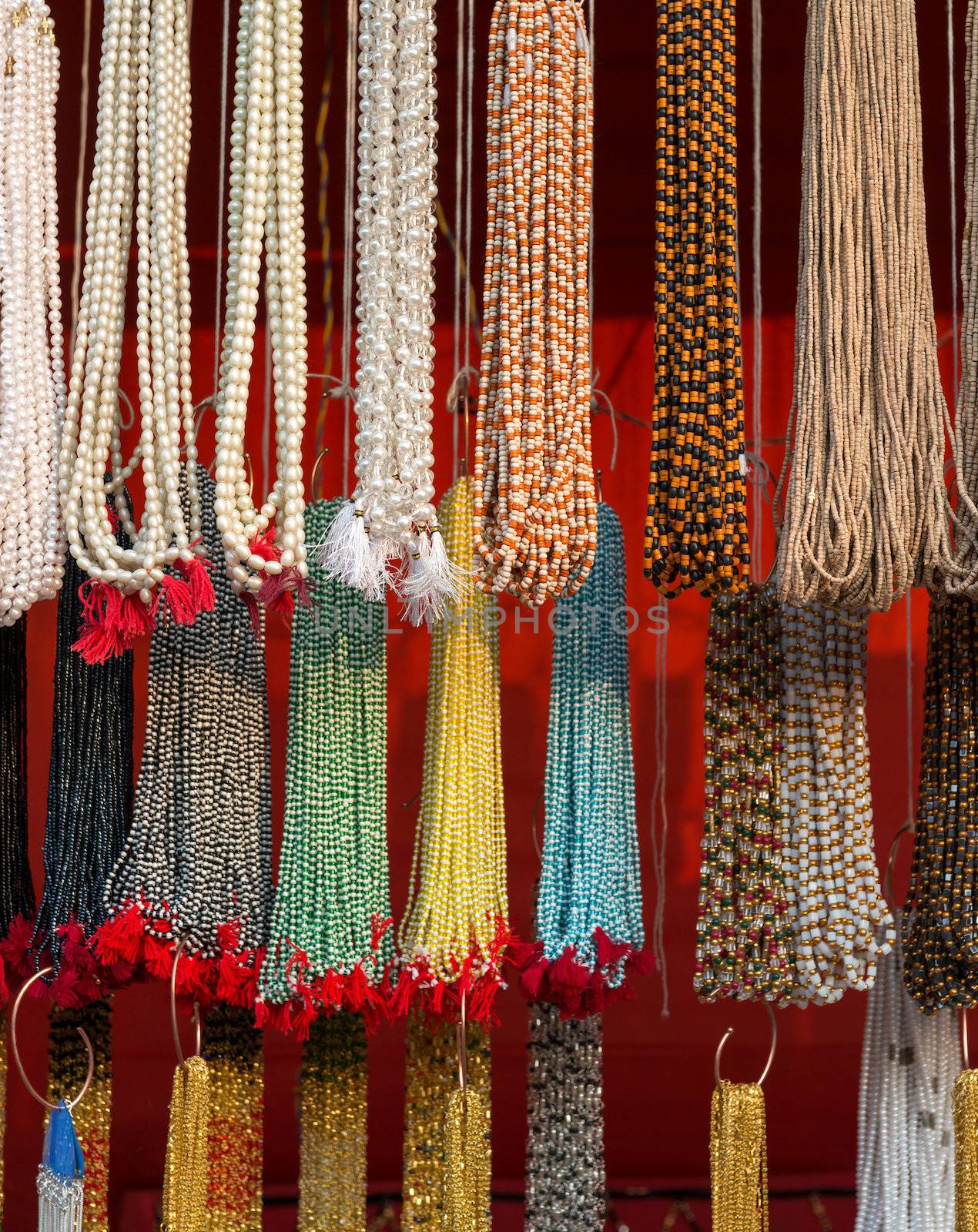 Strands of small colorful beads at the outdoor craft market in India