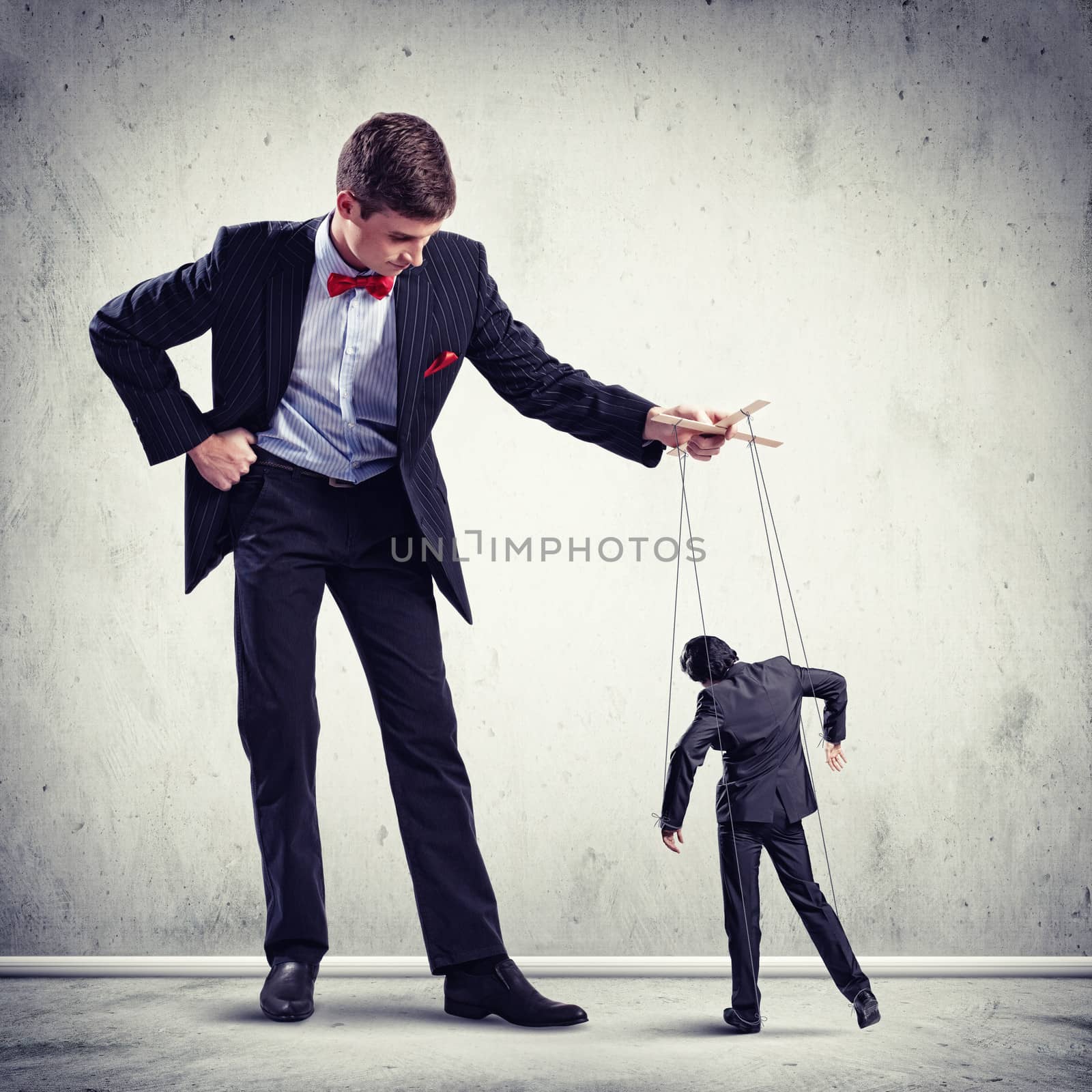 Image of young businessman puppeteer. Leadership concept