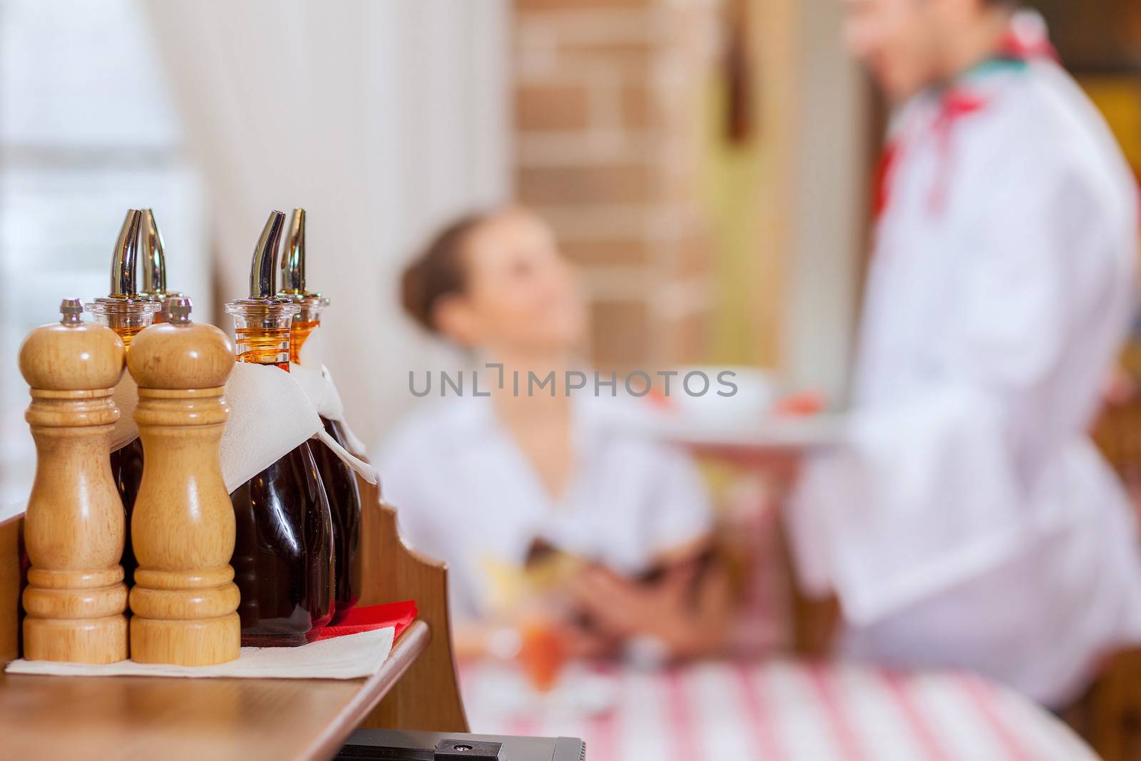 Young woman at restaurant sitting at table