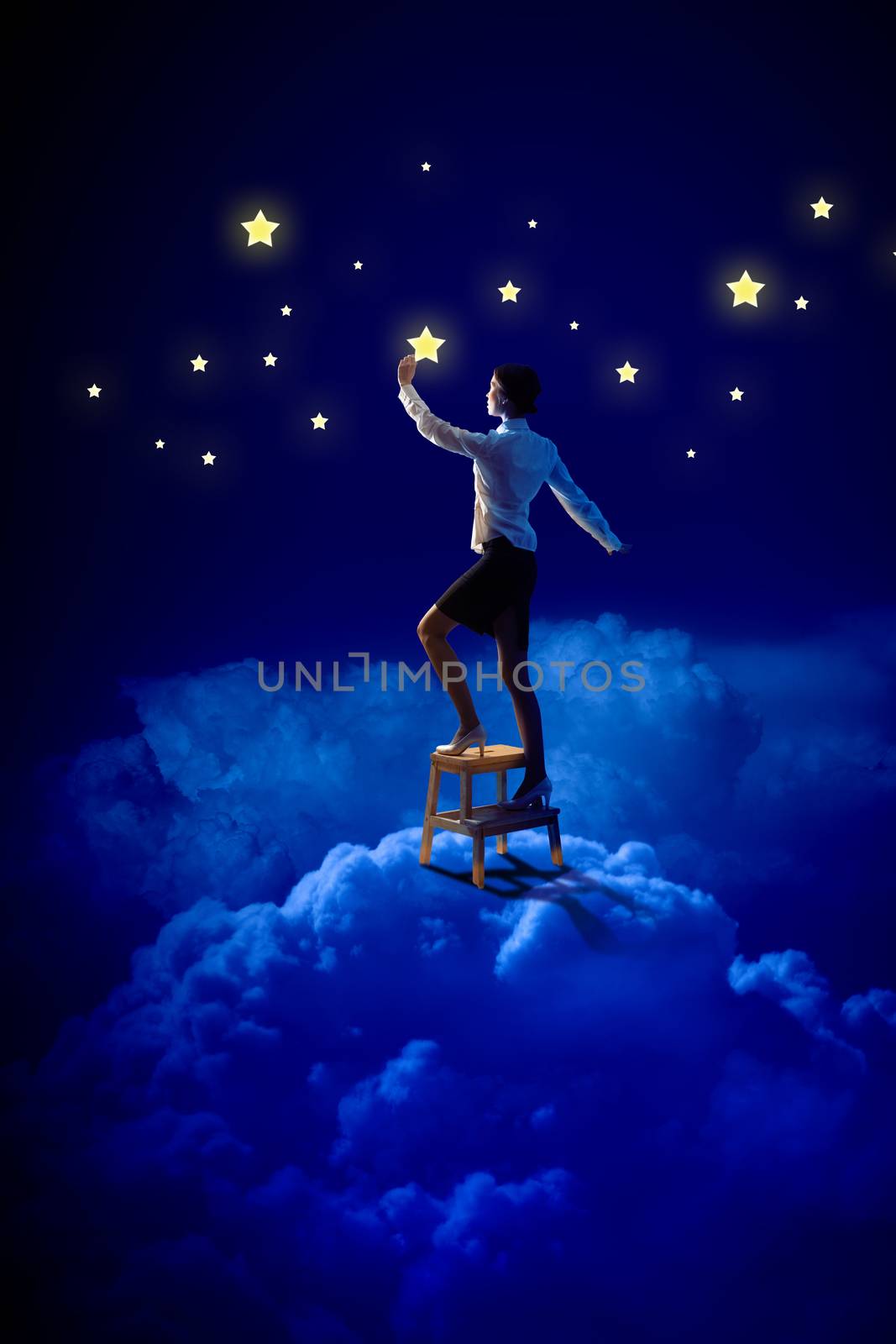 Image of young woman lighting stars in night sky