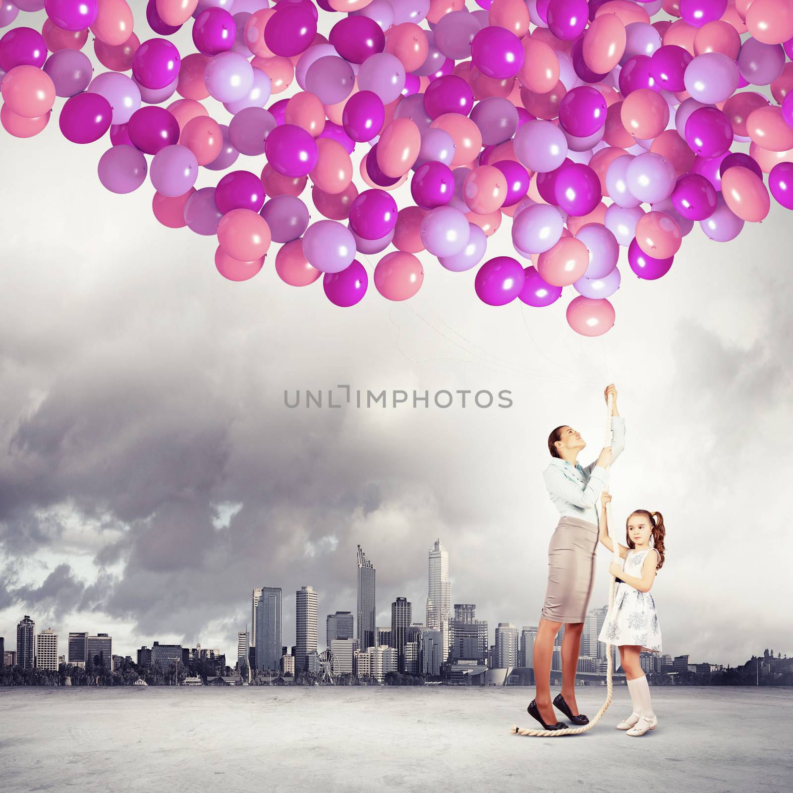 Image of happy family holding bunch of colorful balloons