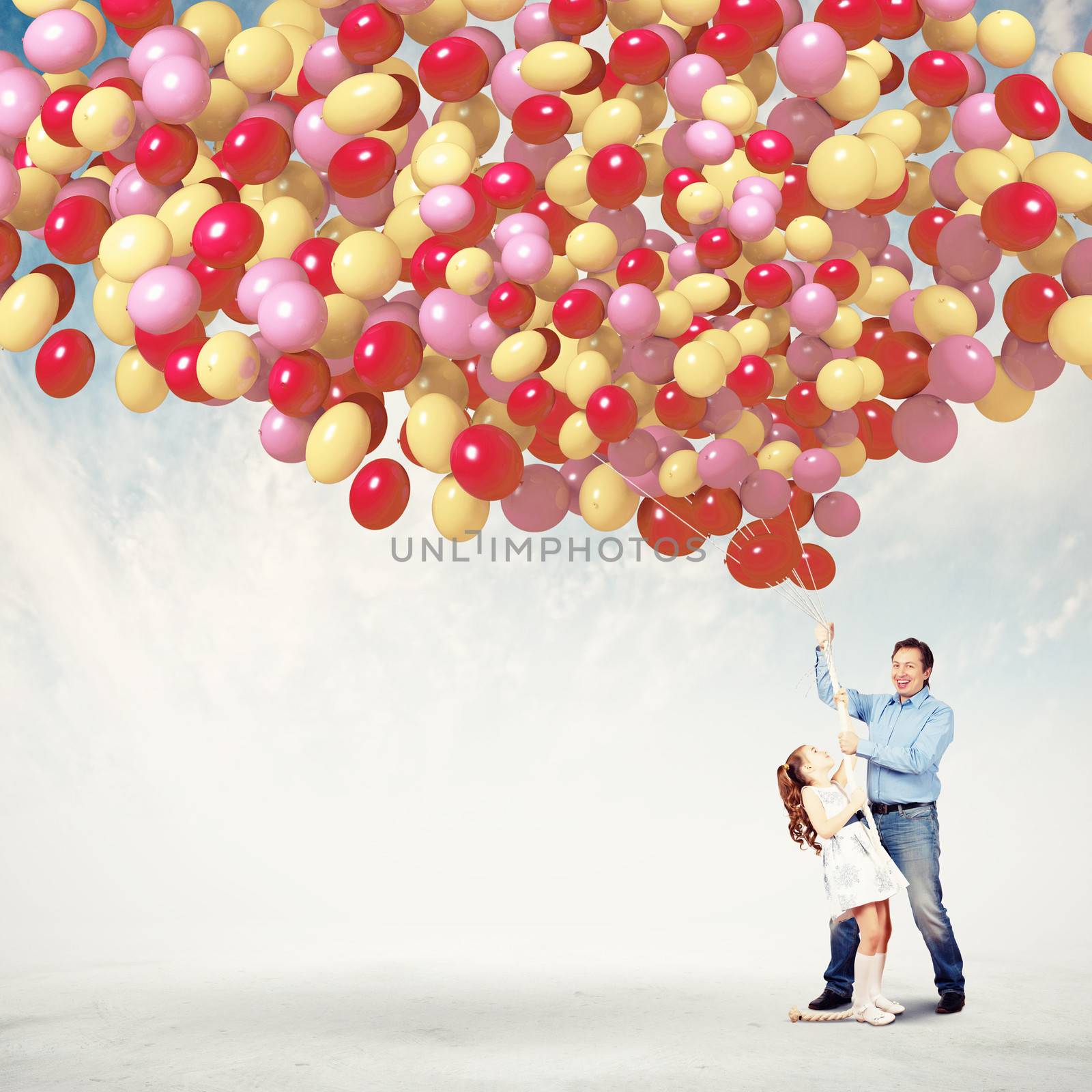 Image of father and daughter holding bunch of colorful balloons
