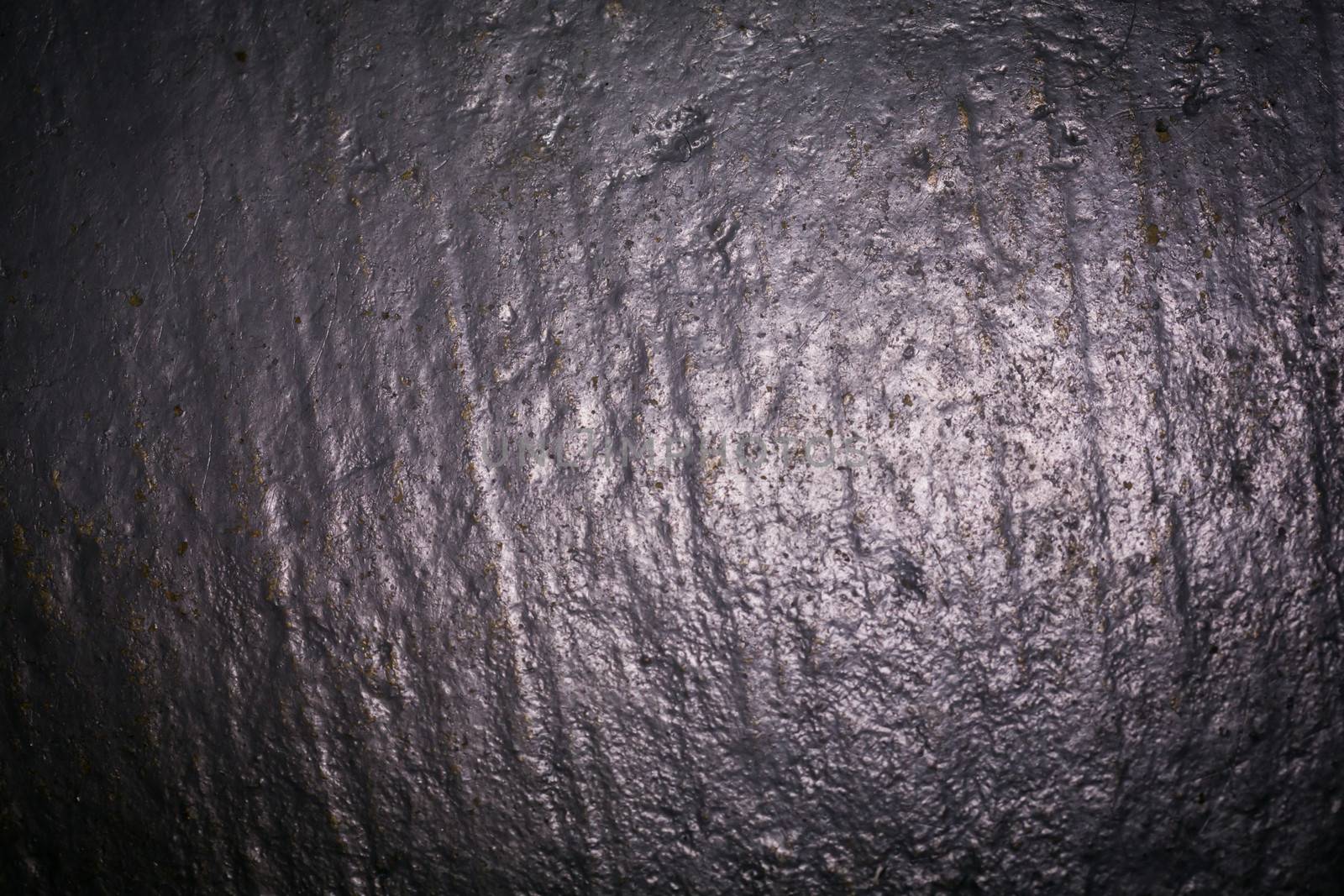 Textured background of dark black wet concrete floor