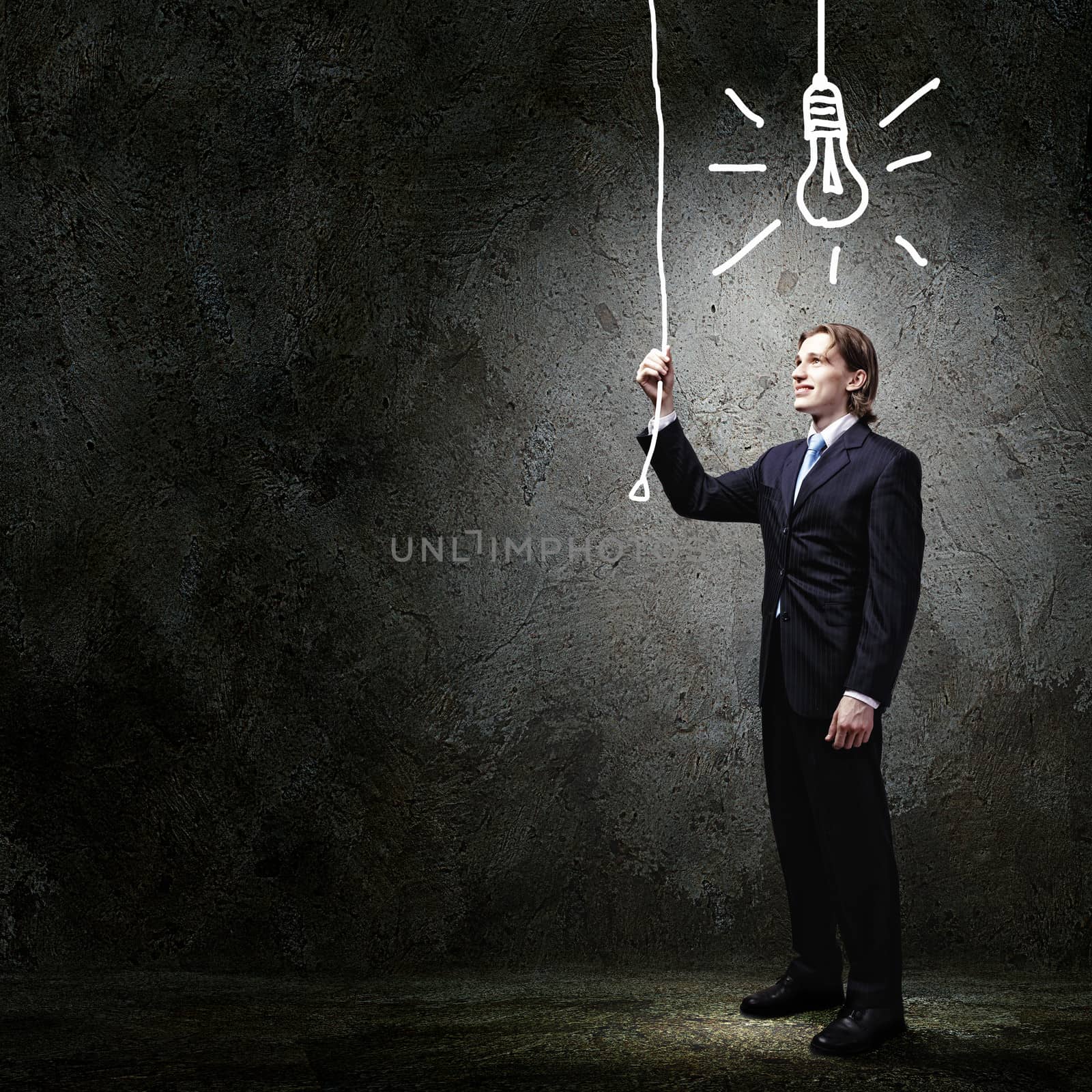 Image of businessman in black suit against dark background