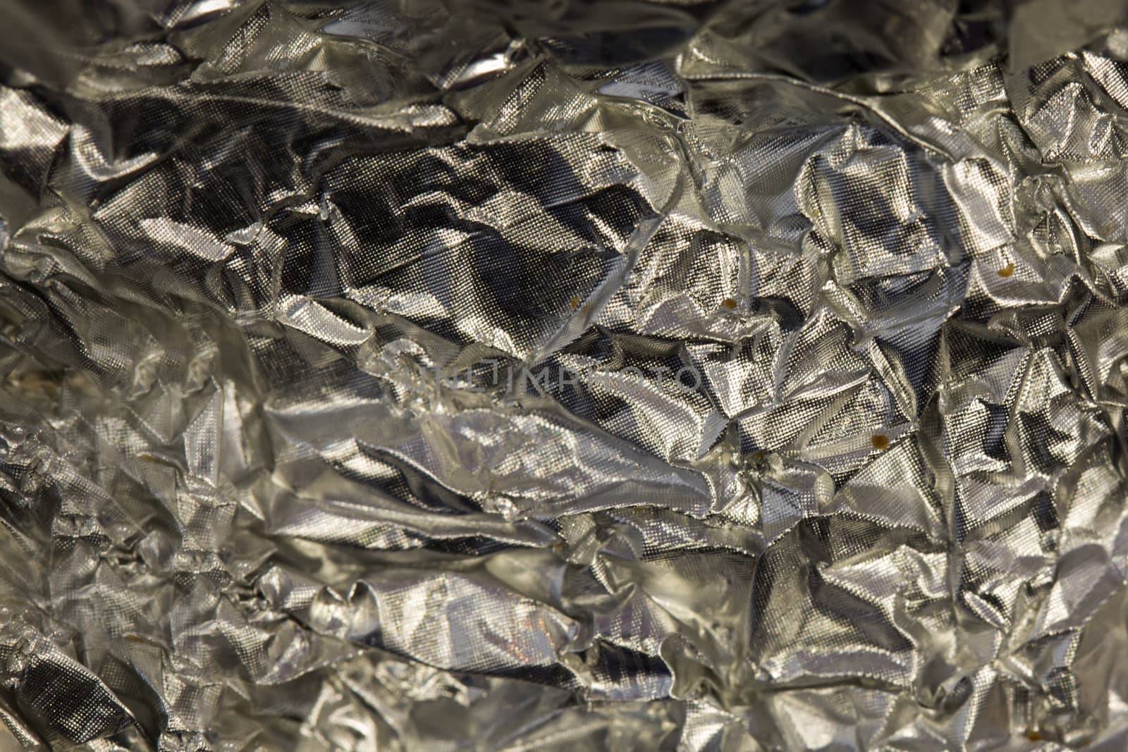 Abstract crumpled tin foil, closeup background texture