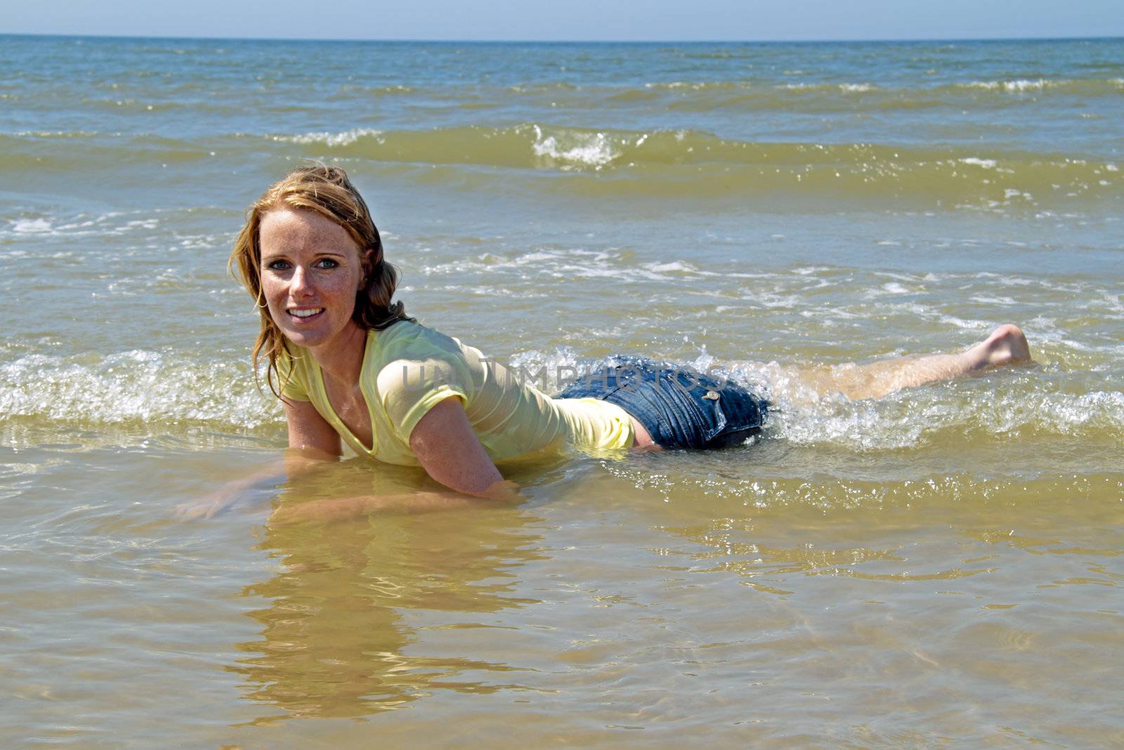 Beautiful blonde woman relaxing in the water from the north sea  by devy