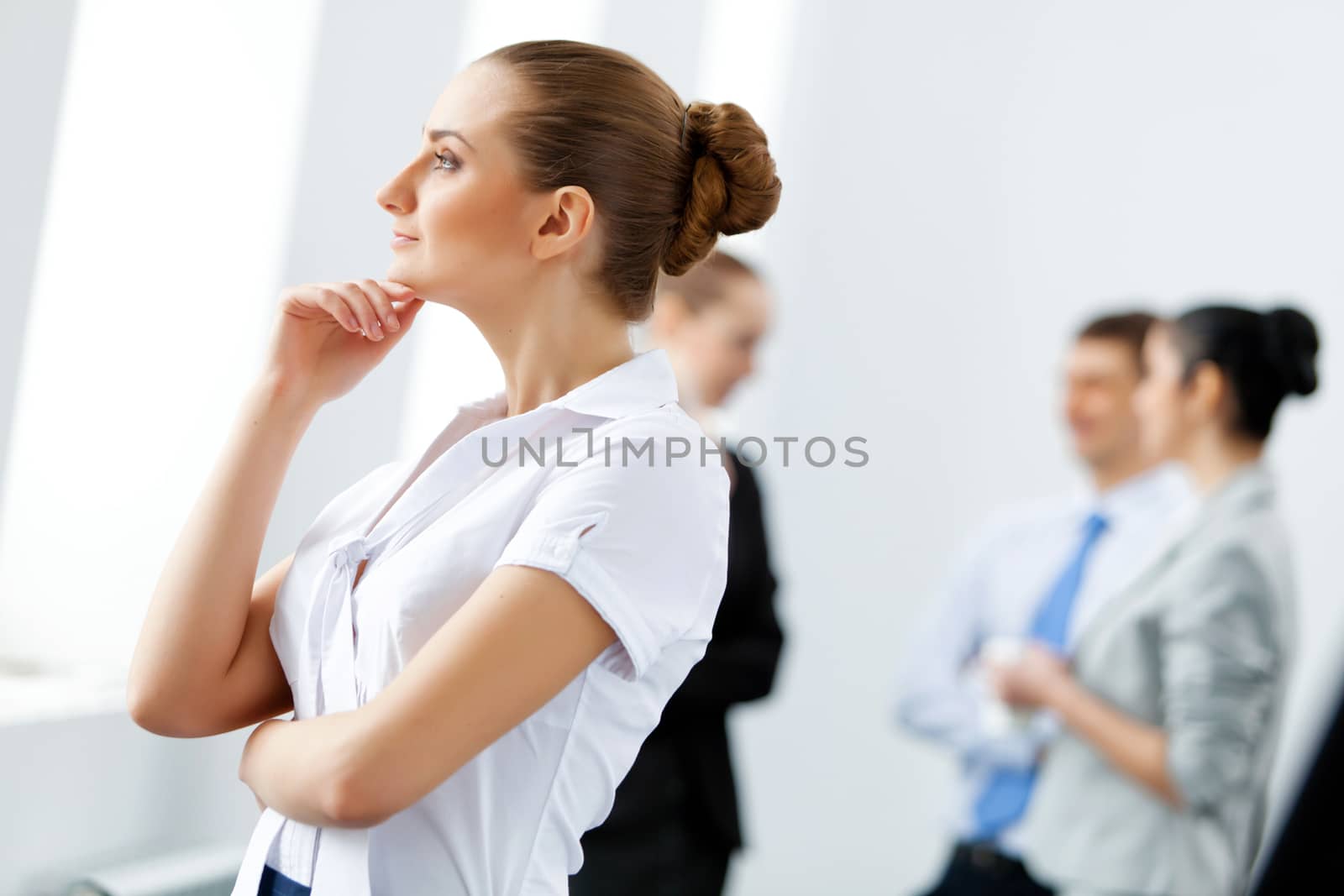 Image of four pretty young businesswomen standing in row