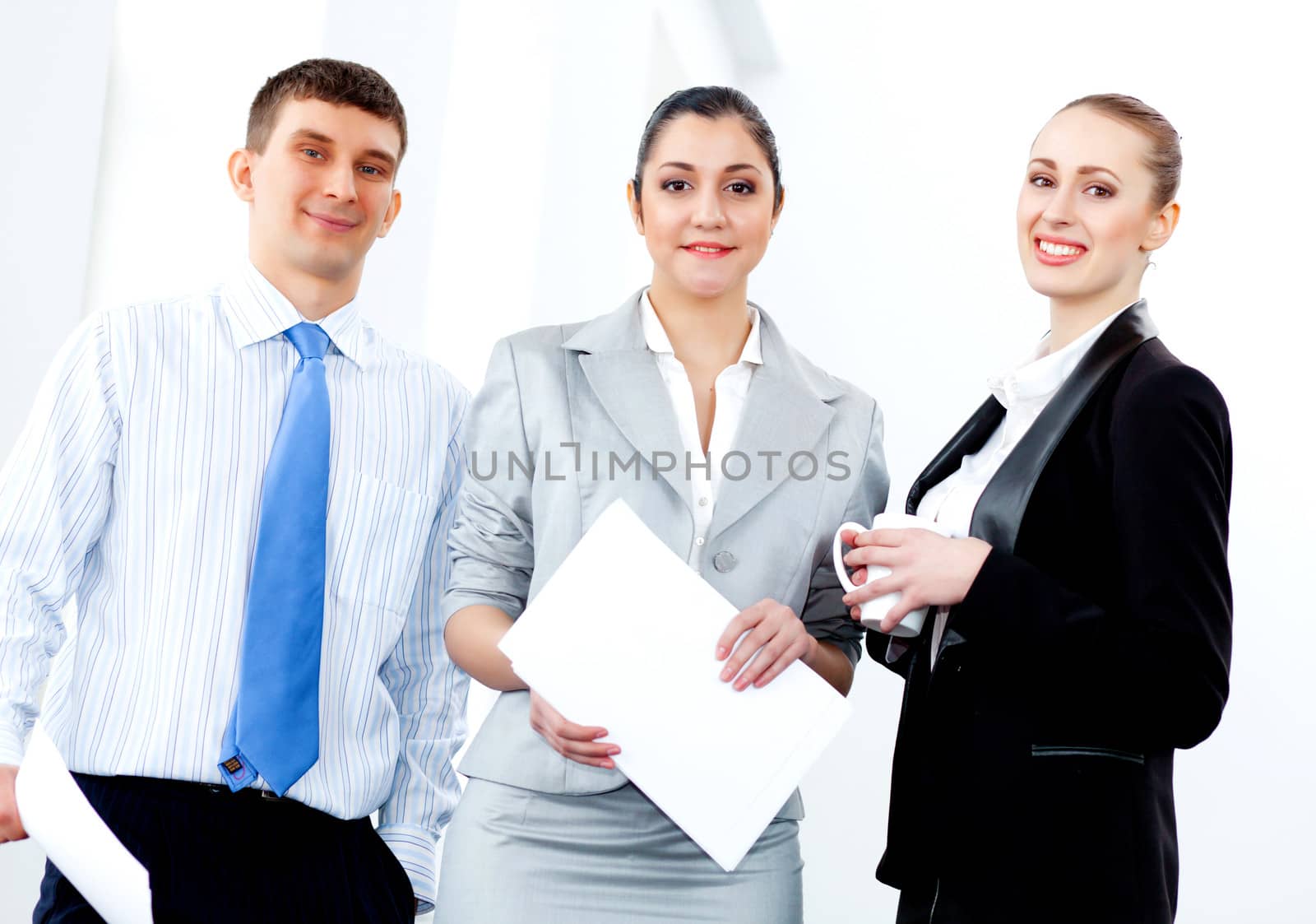 Image of three young businesspeople laughing joyfully