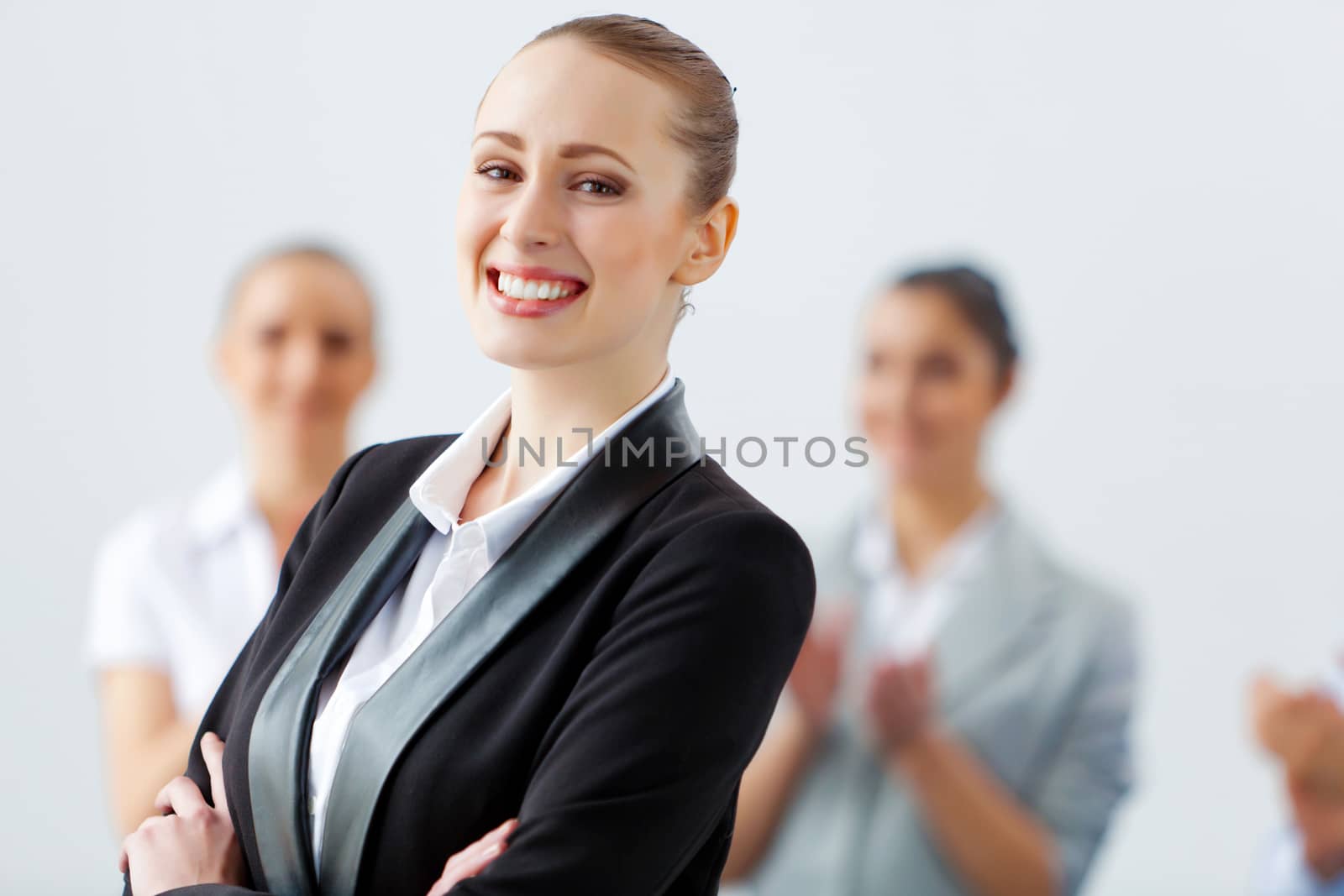 Image of three young businesspeople laughing joyfully