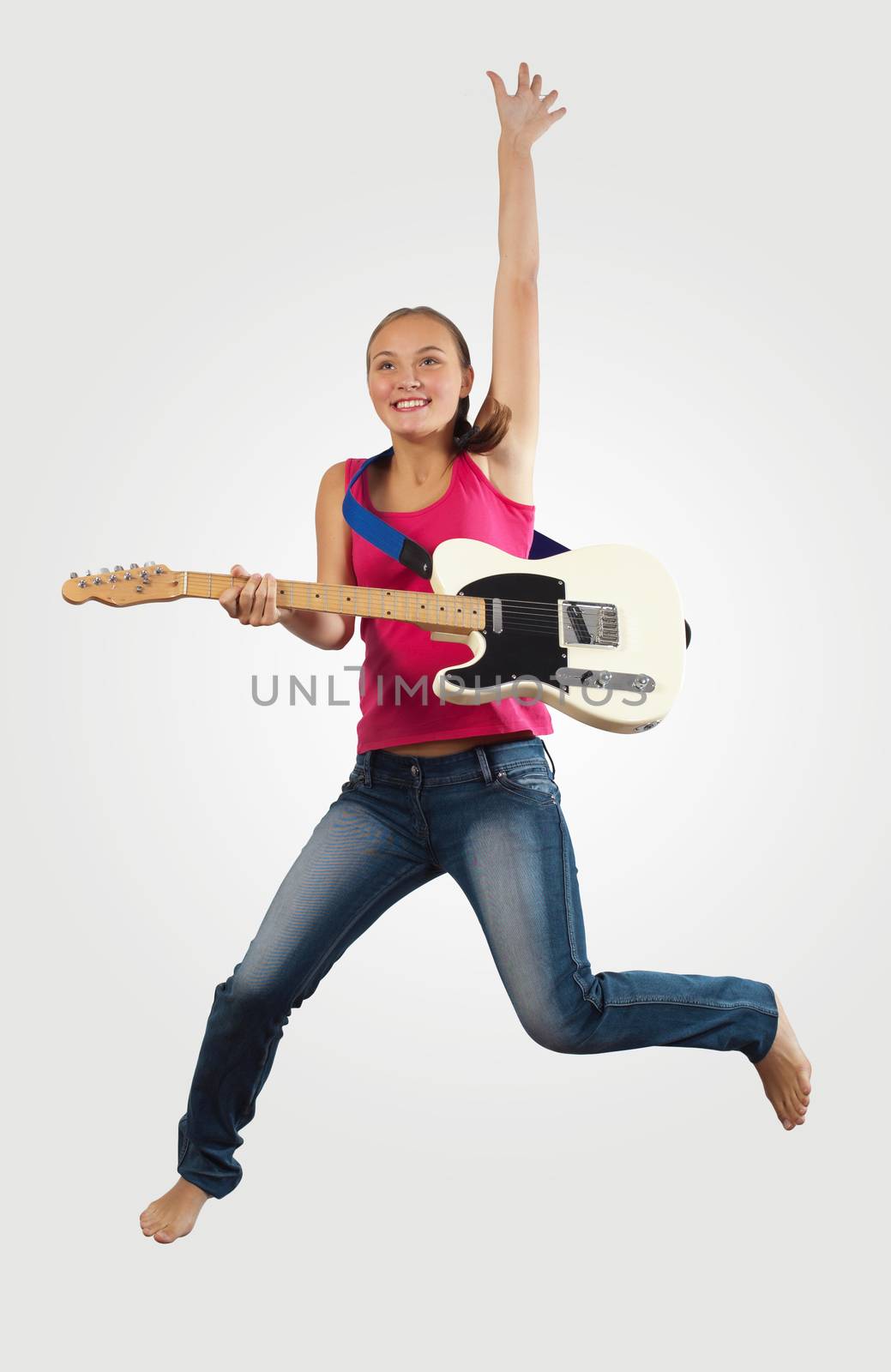 young woman playing on electro guitar and jumping by sergey_nivens