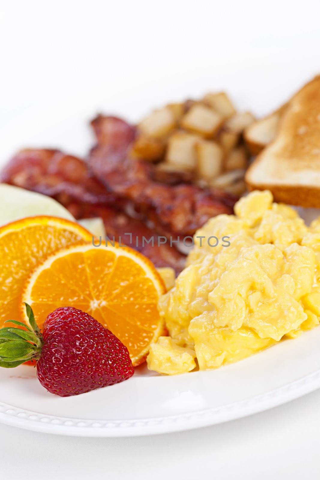 Delicious breakfast of scrambled eggs toast and bacon