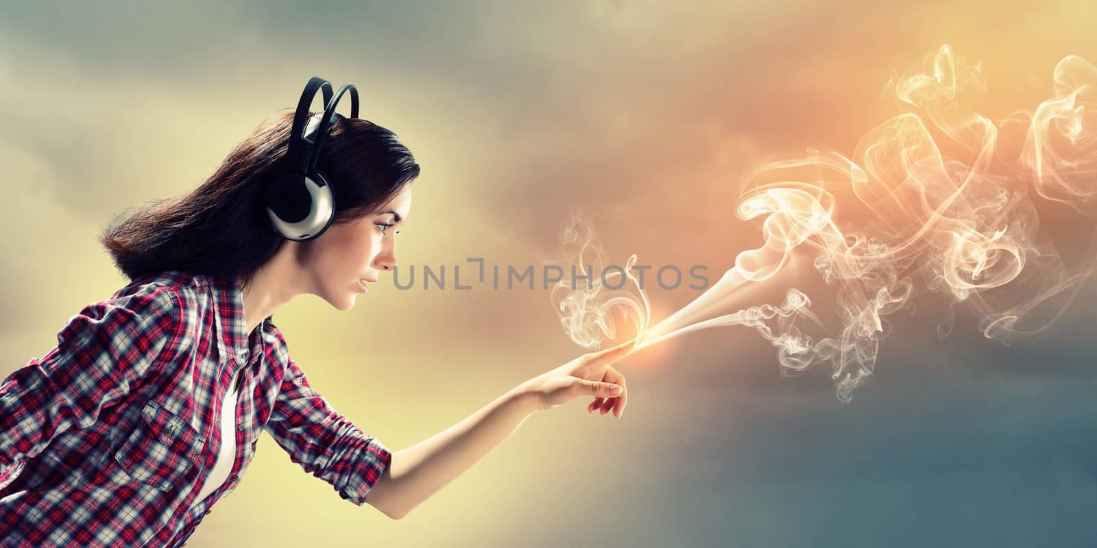 Image of young pretty woman with headphones. Side view