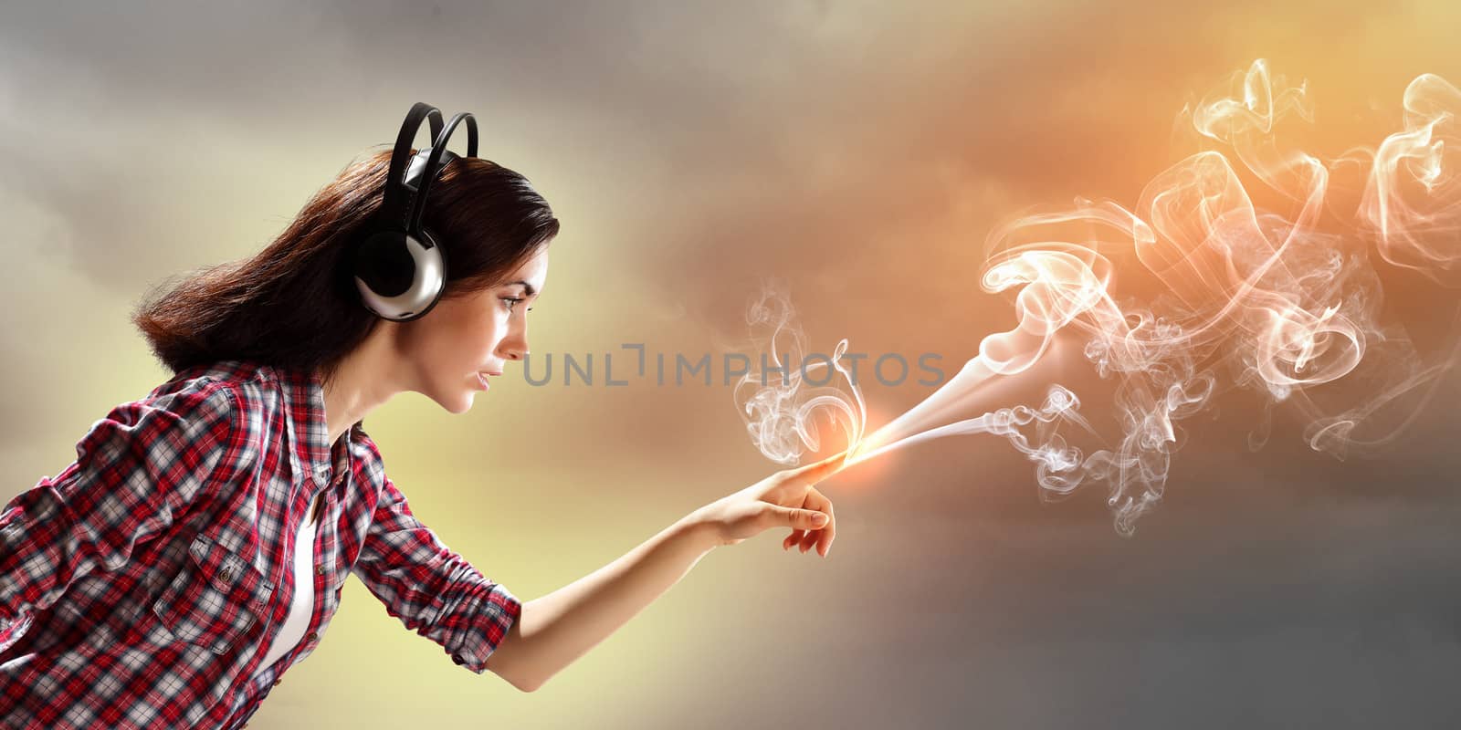 Image of young pretty woman with headphones. Side view
