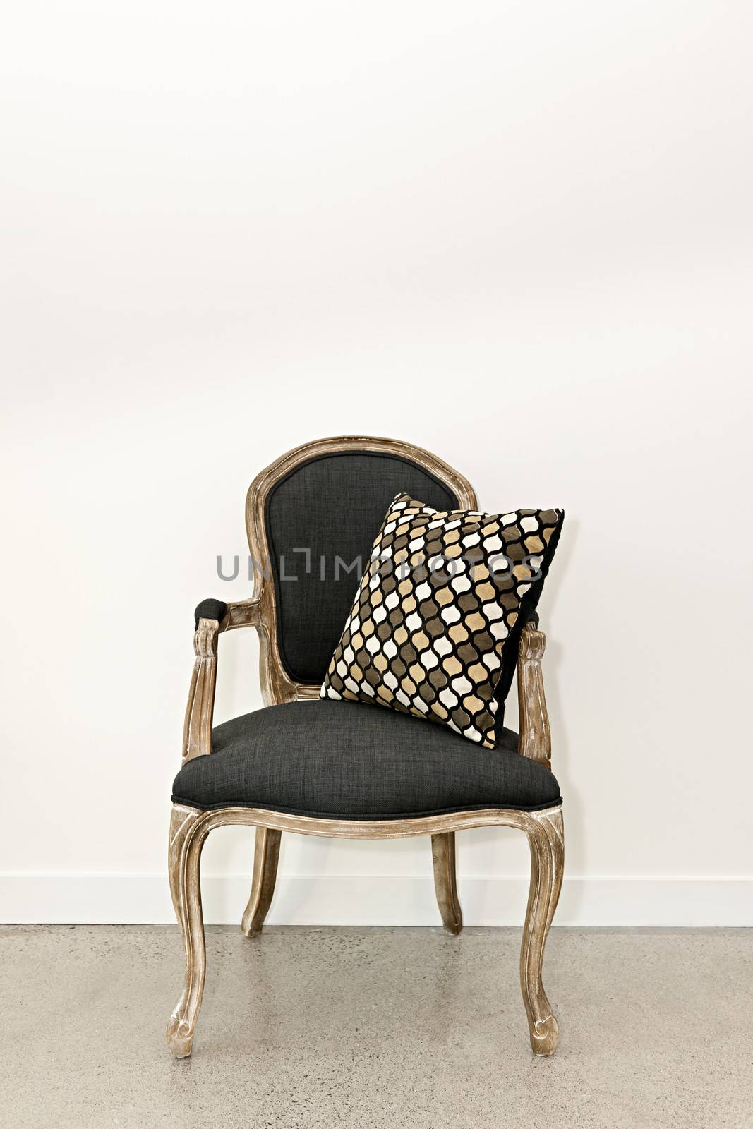 Antique armchair furniture with cushion against white wall