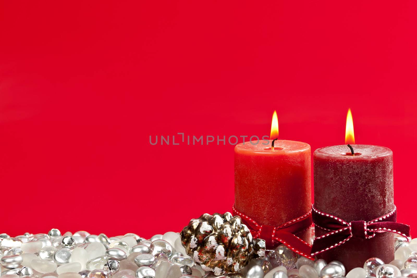 Christmas candles and decorations on red background
