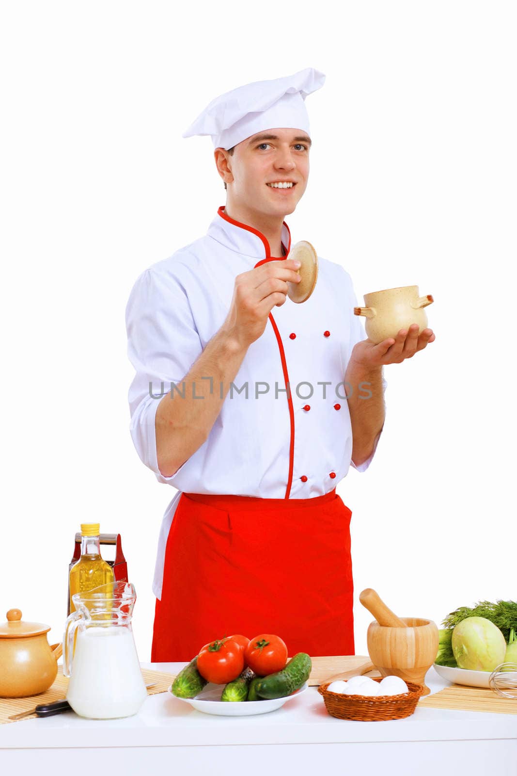 Young cook preparing food wearing a red apron