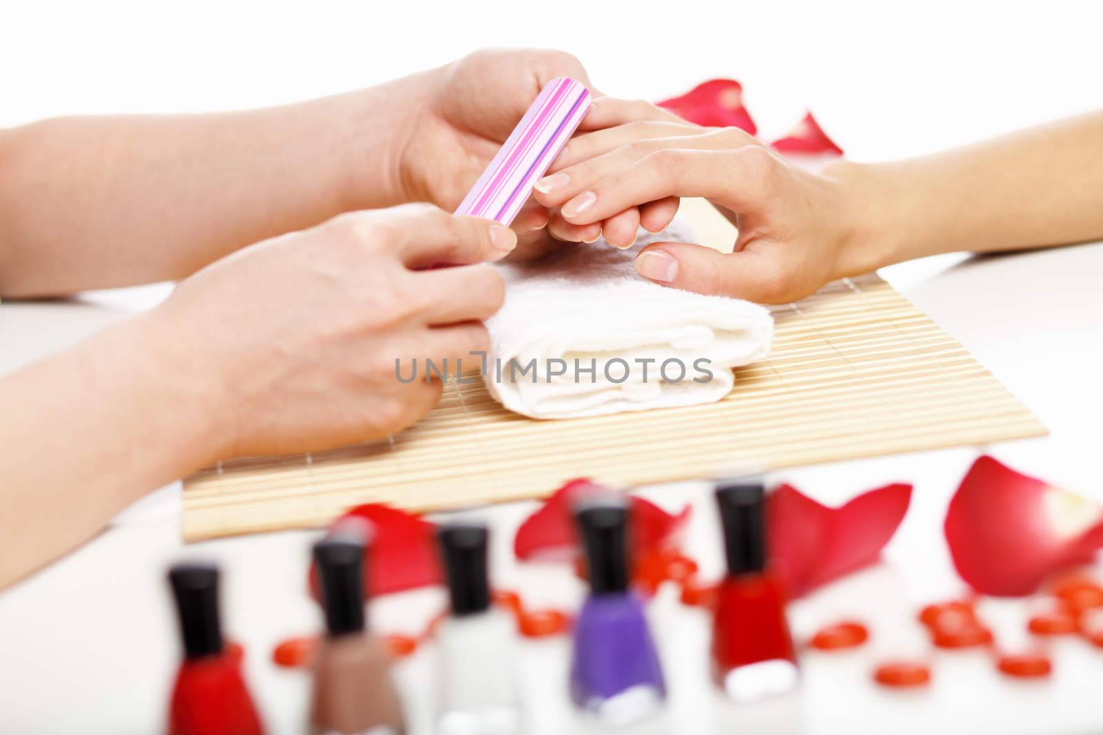 Woman is getting manicure by sergey_nivens