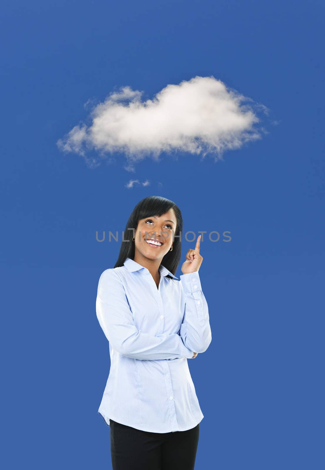 Smiling black woman thinking about cloud computing