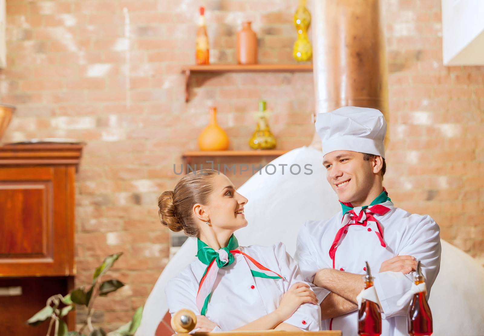 Portrait of two cooks with crossed arms looking at the camera