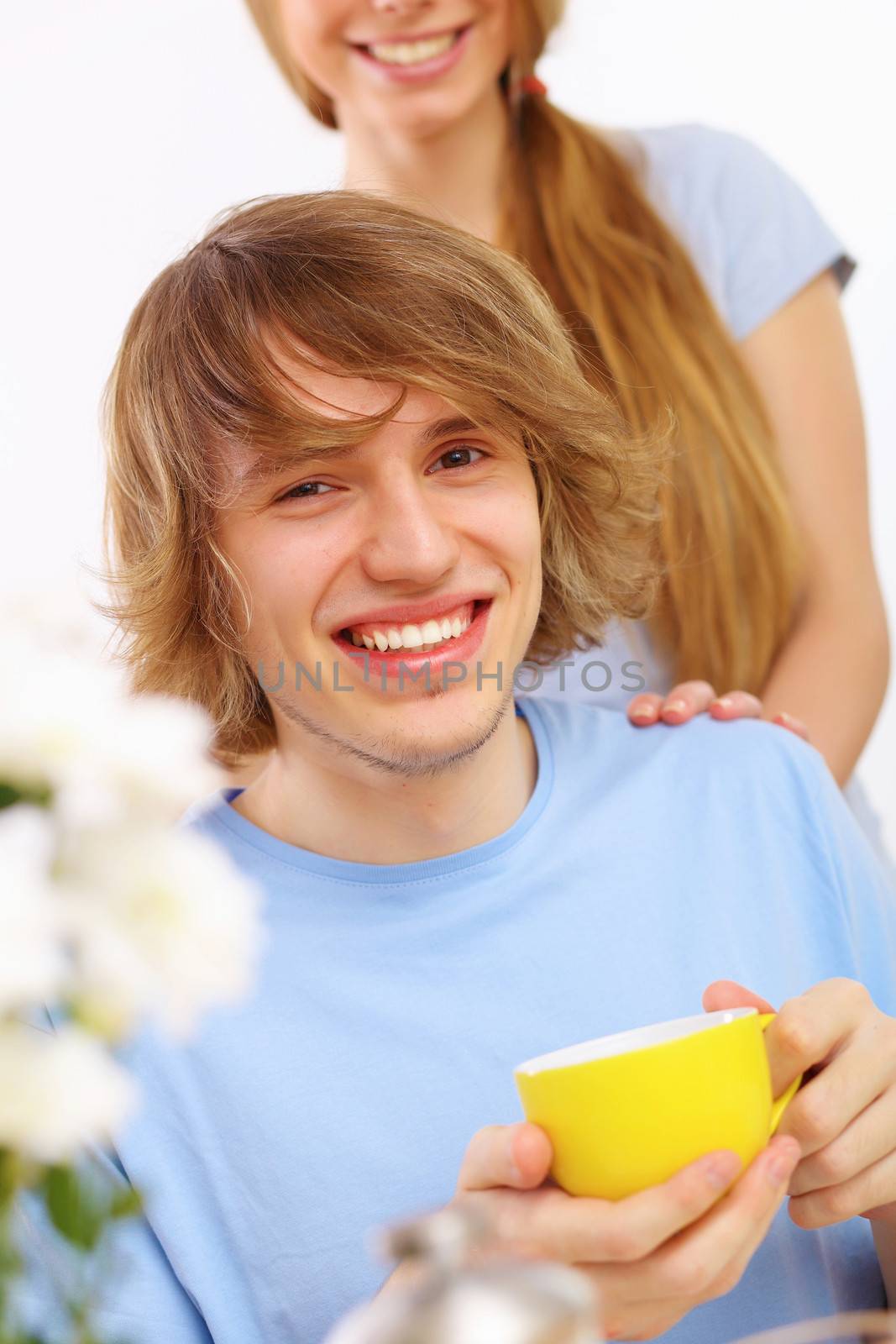 Young happy man drinking tea at home