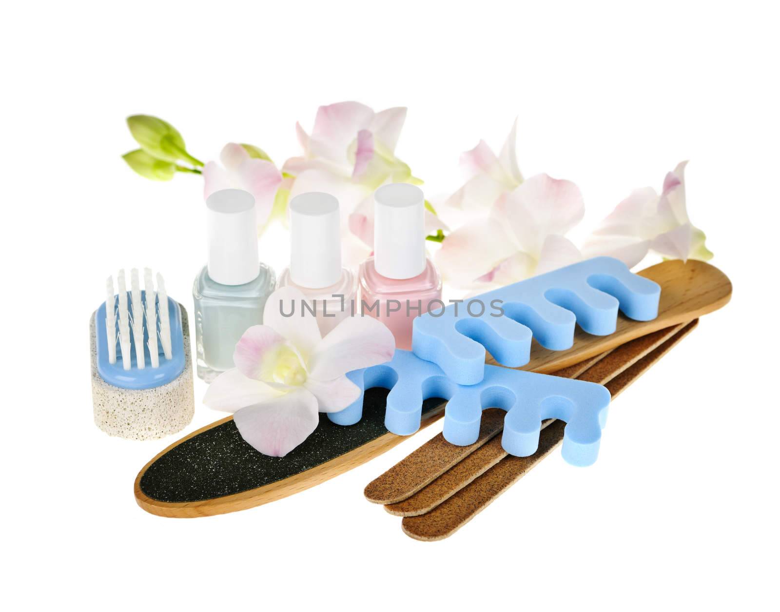 Pedicure accessories and nail polish on white background