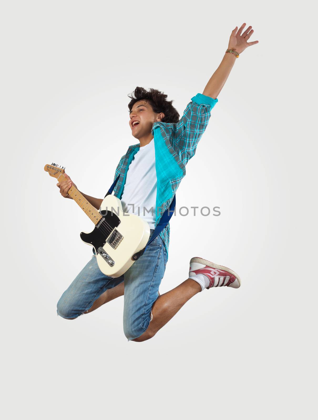 young man playing on electro guitar and jumping by sergey_nivens