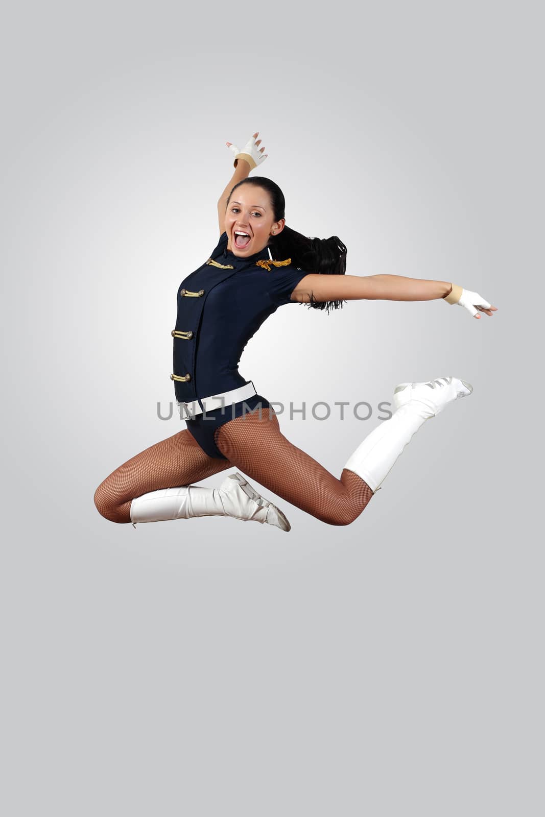 Young female dancer jumping against white background