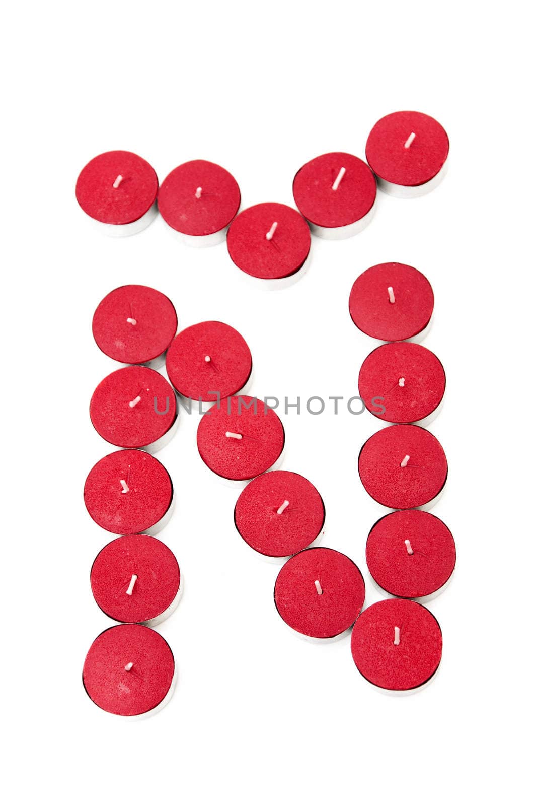 Letter � formed by candles on a white background