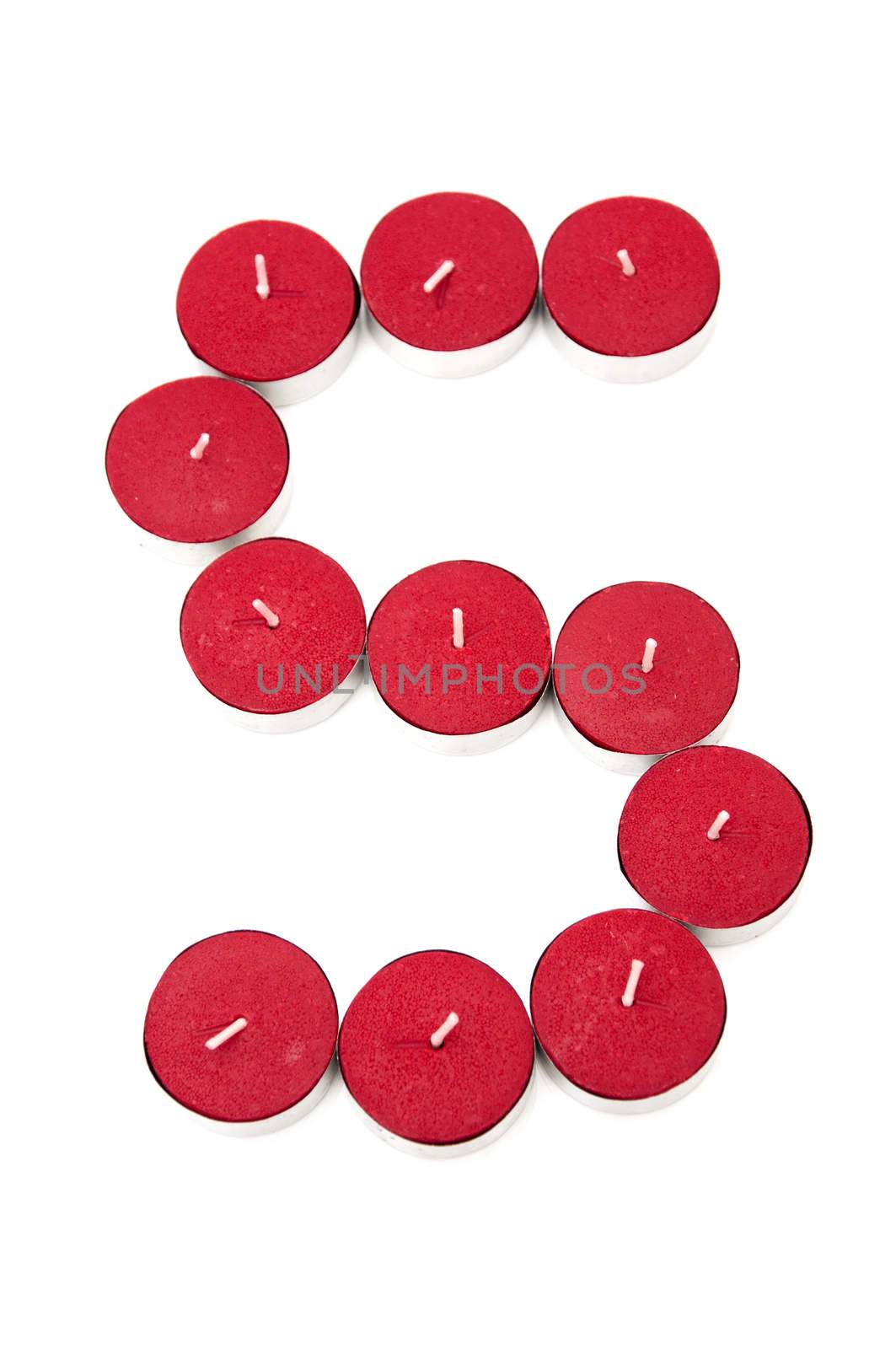 Letter S formed by candles on a white background