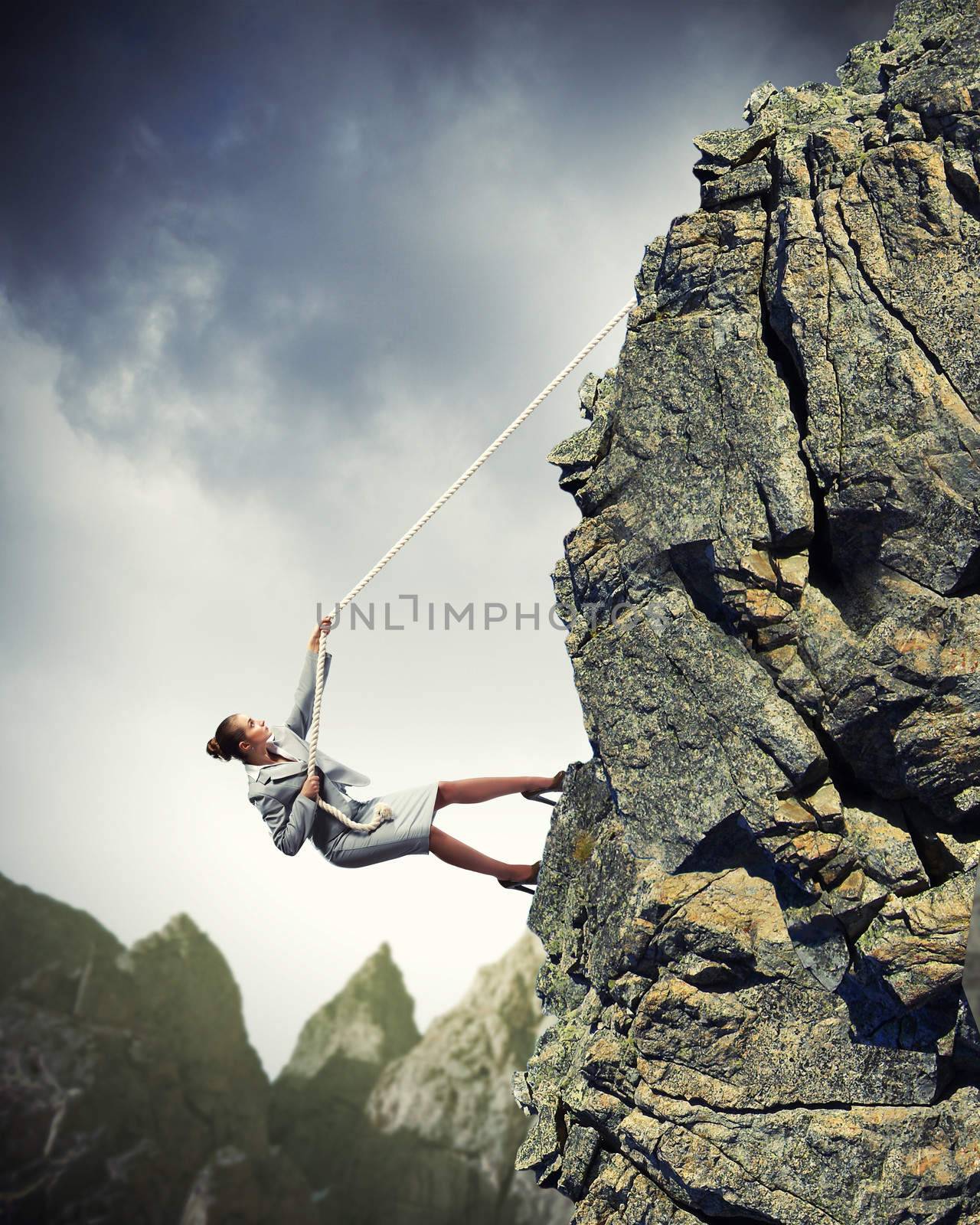 businesswoman climbing mountain by sergey_nivens