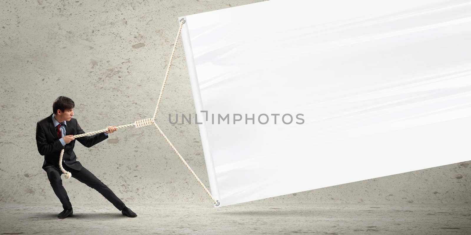 Businessman pulling blank banner by sergey_nivens