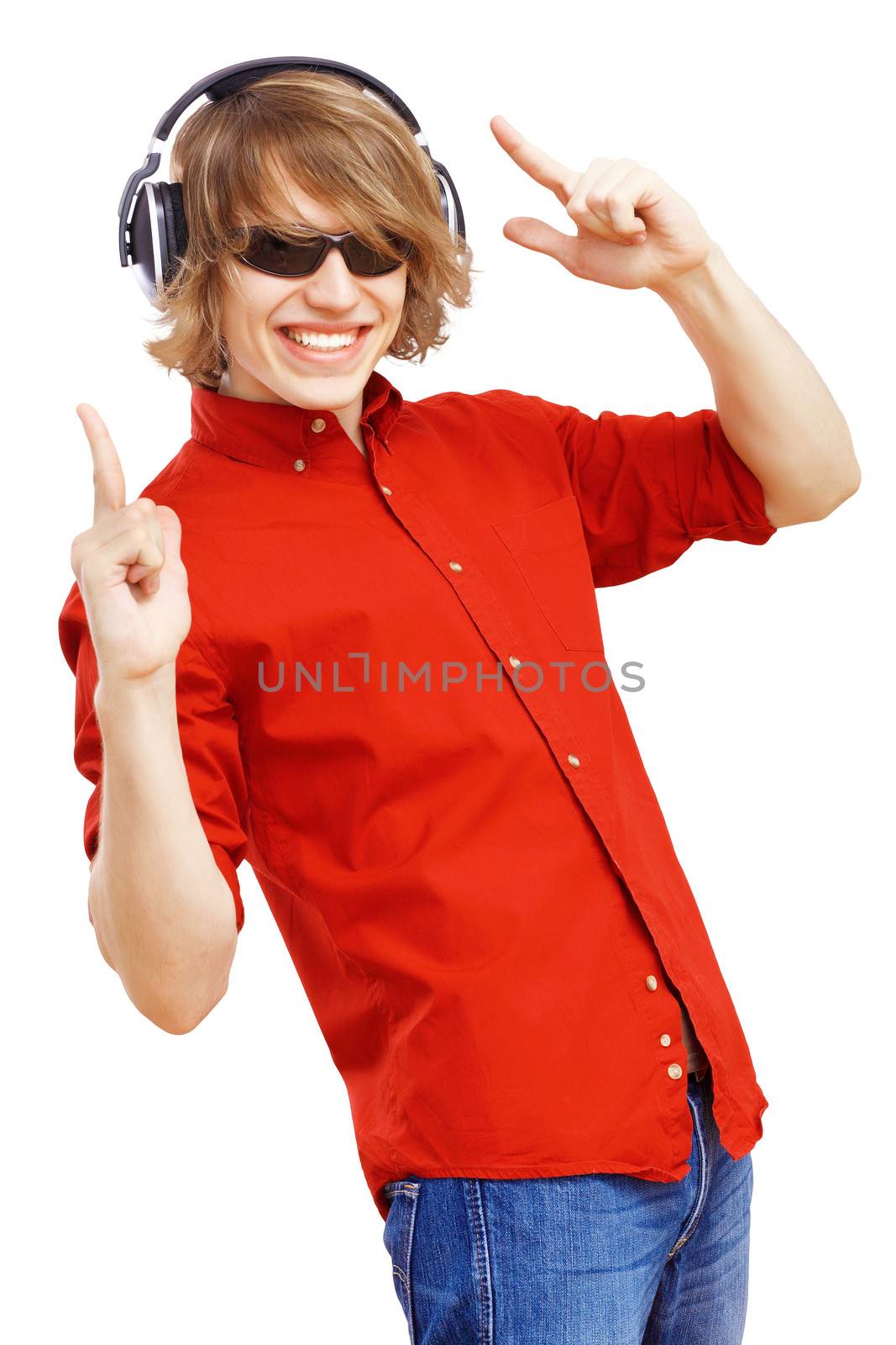 Happy smiling young man dancing and listening to music