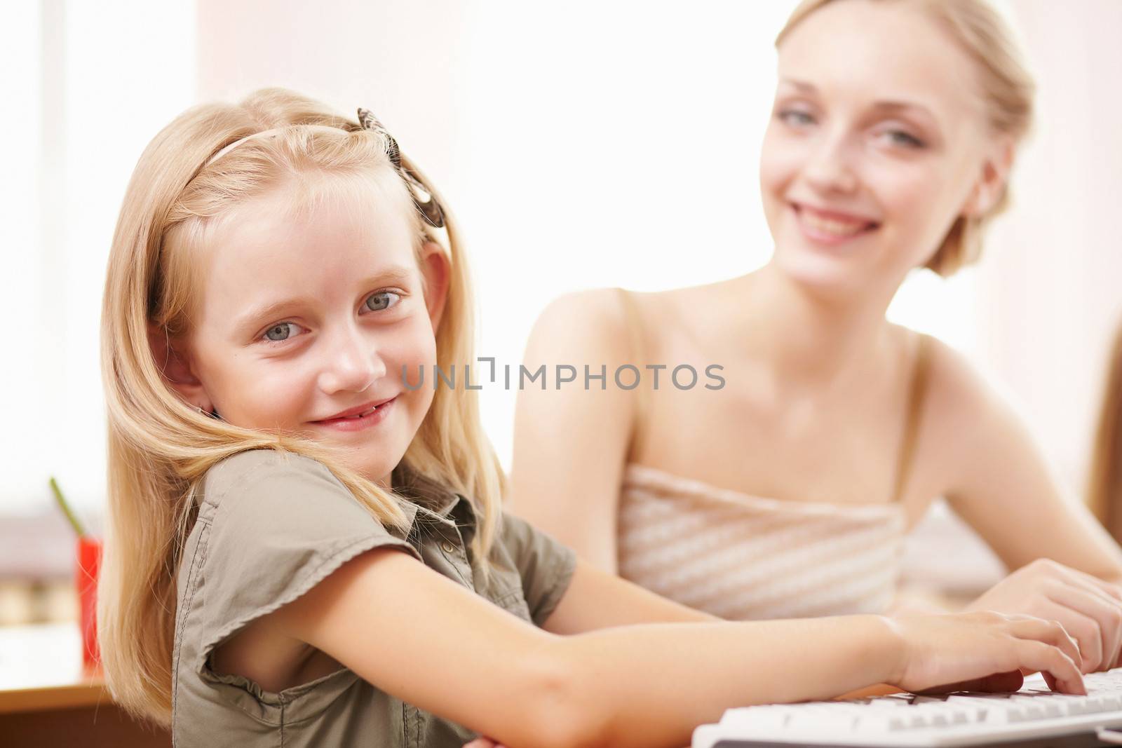 Young female teacher working with children at school