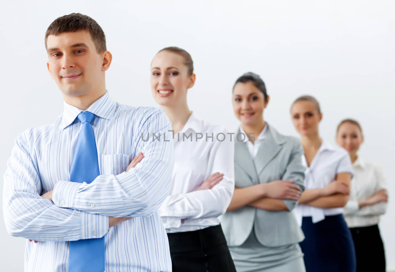 Group of businesspeople smiling standing with arms crossed