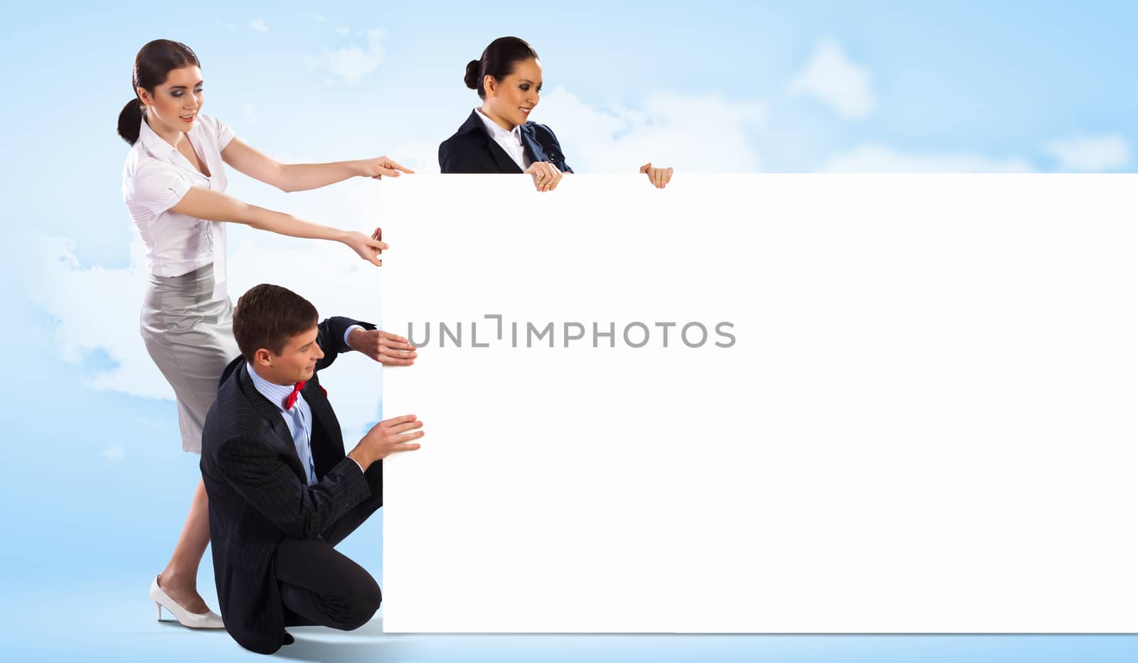 Image of three young people holding blank banner against blue background. Place for text