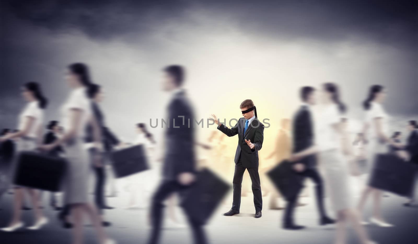 Image of businessman in blindfold walking among group of people